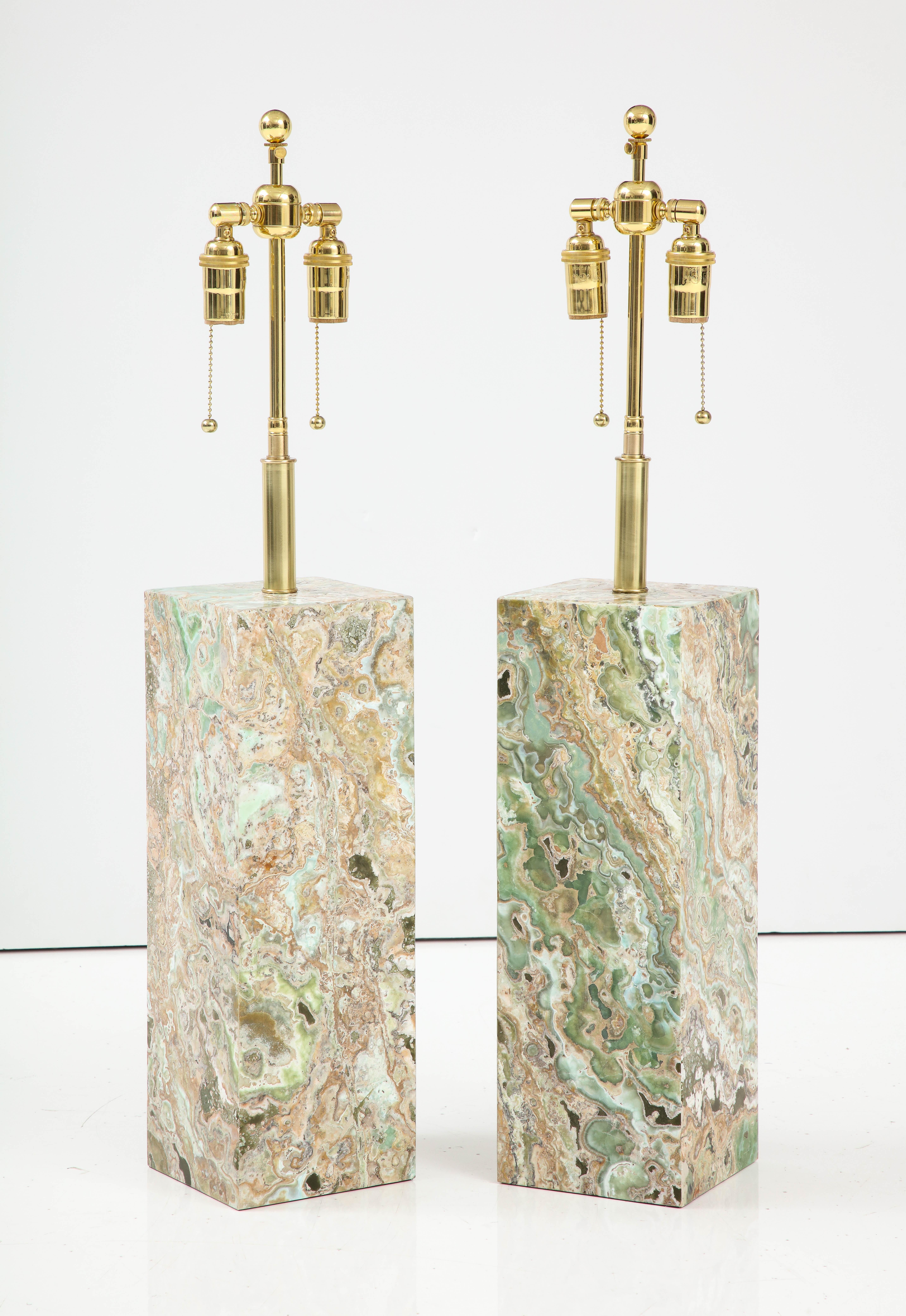 Spectacular pair of large Onyx table lamps.
This beautifully made pair of lamps have been Newly rewired with adjustable polished brass double clusters and silk rayon cords that take standard size light bulbs.
The height to the top of the Onyx is 18