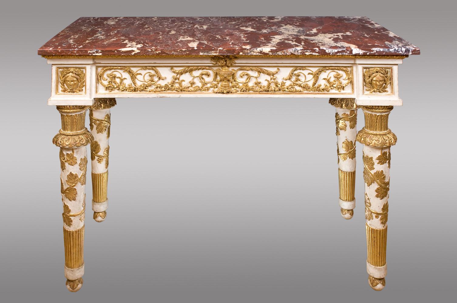 Stucoed and gilded carved wood.
Fronts and sides decorated with scrolls and garlands of flowers, finished in laureate females heads.
Legs decorated with acanthus leaves and top and vine leaves that descend around.
Each console with
