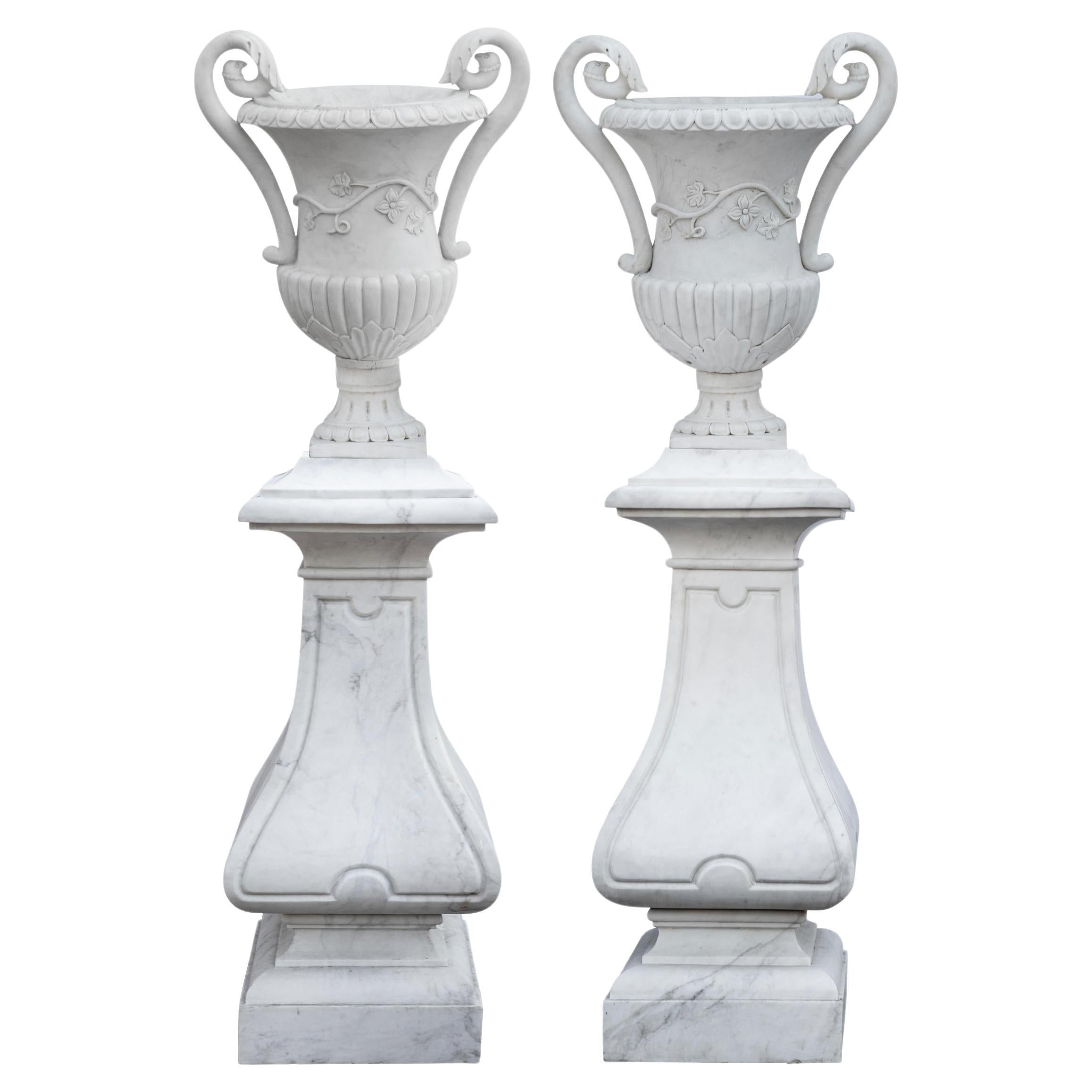 Spectacular Pair of White Marble Classic Form Handled Urns w/ Baluster Pedestals For Sale