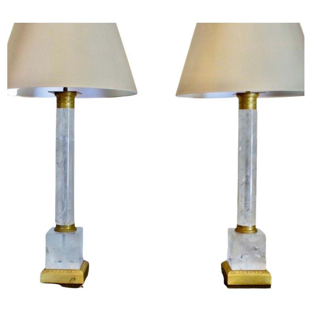 A spectacular large pair of ormolu bronze mounted rock crystal column form table lamps, each with two edison lights.