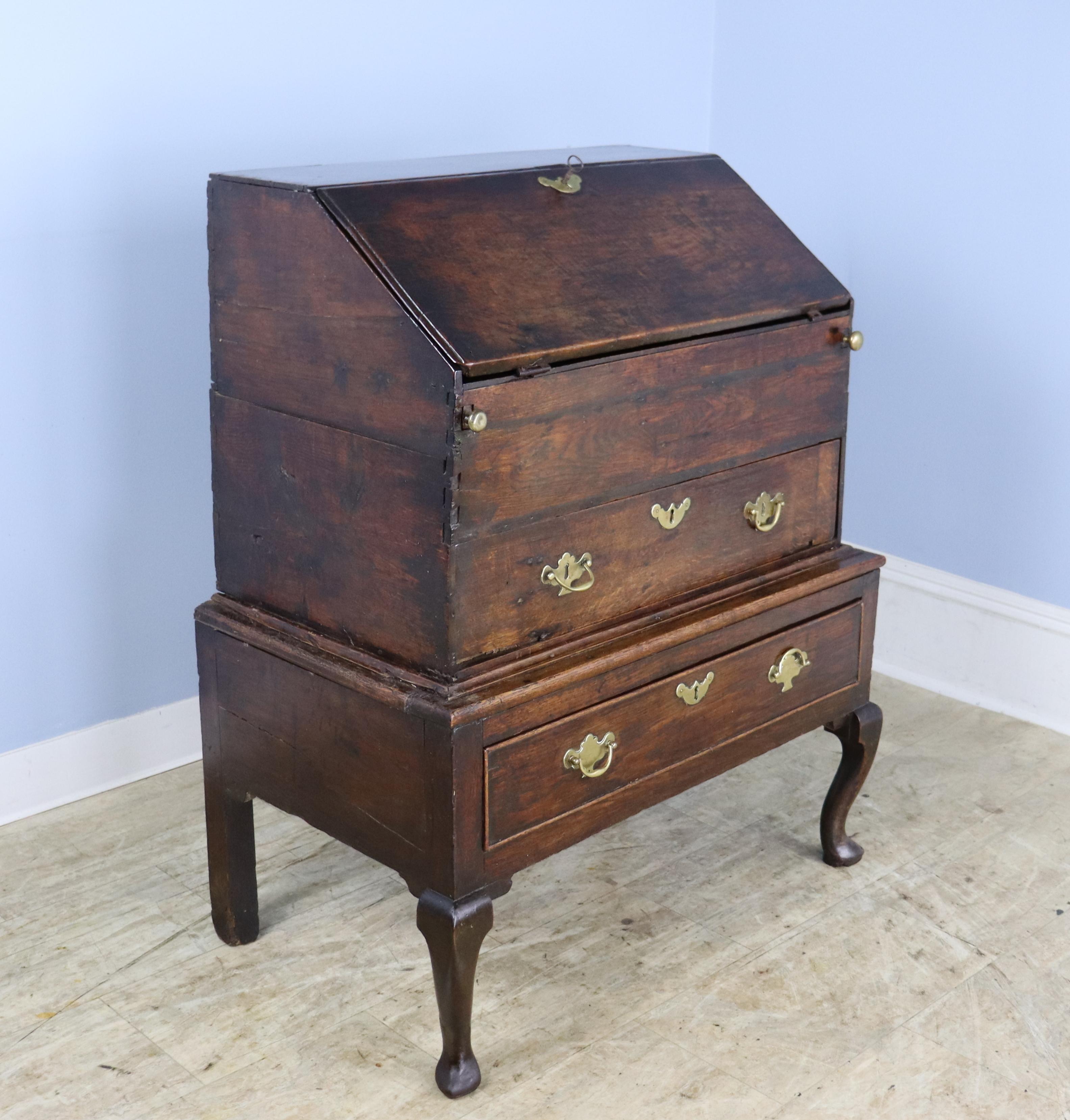 A rare example of 17th Century period furniture, this wonderful oak clerk's desk is in very fine preserved condition.  The original key to the drop down writing surface works well, and the many drawers open and close easily.  Shown in thumbnails are