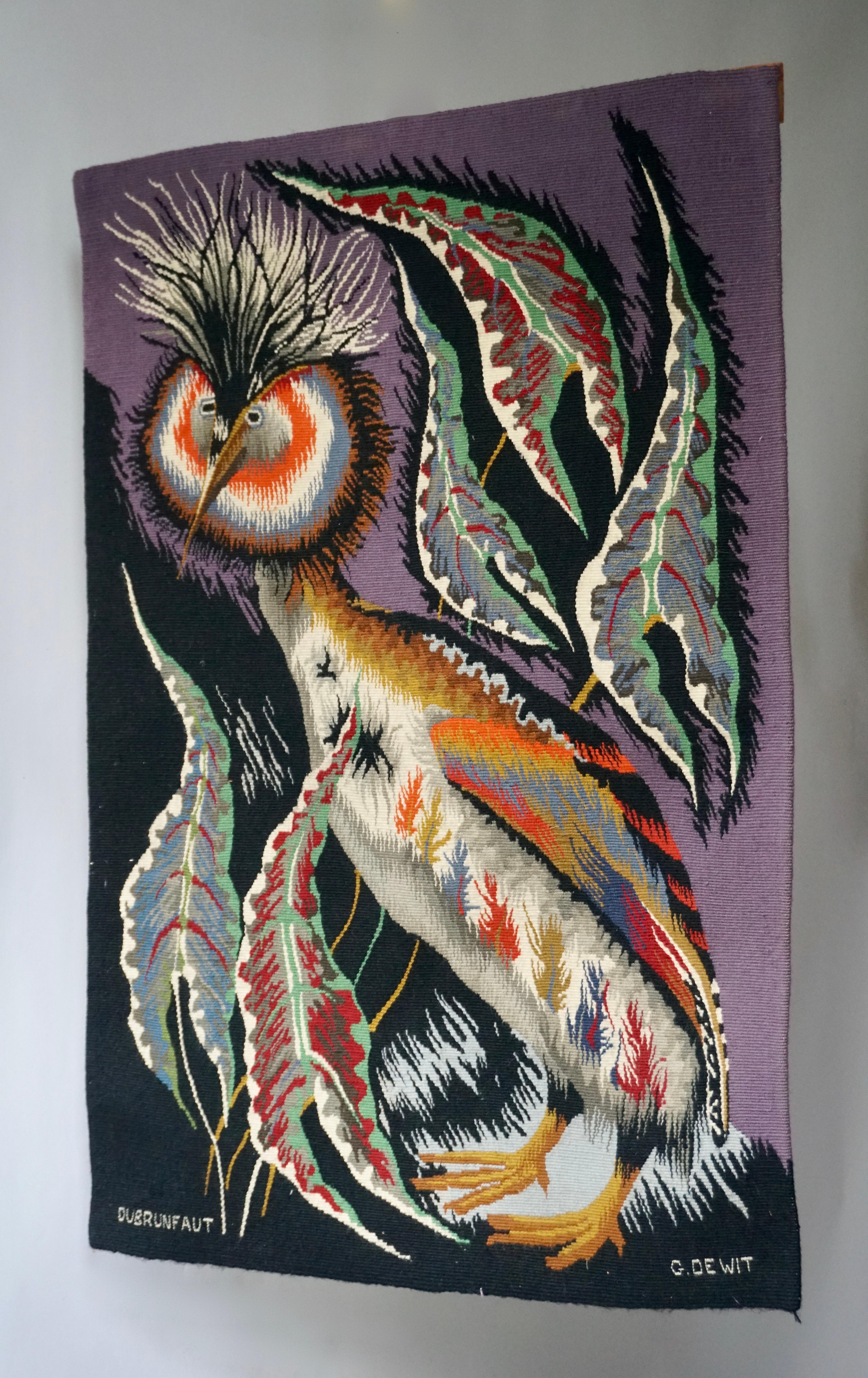 Rare and colorful tapestry of an ornamental crowned crane bird with black and purple background.
Signed by renown Belgian artist Edmont Dubrunfaut, circa 1950.