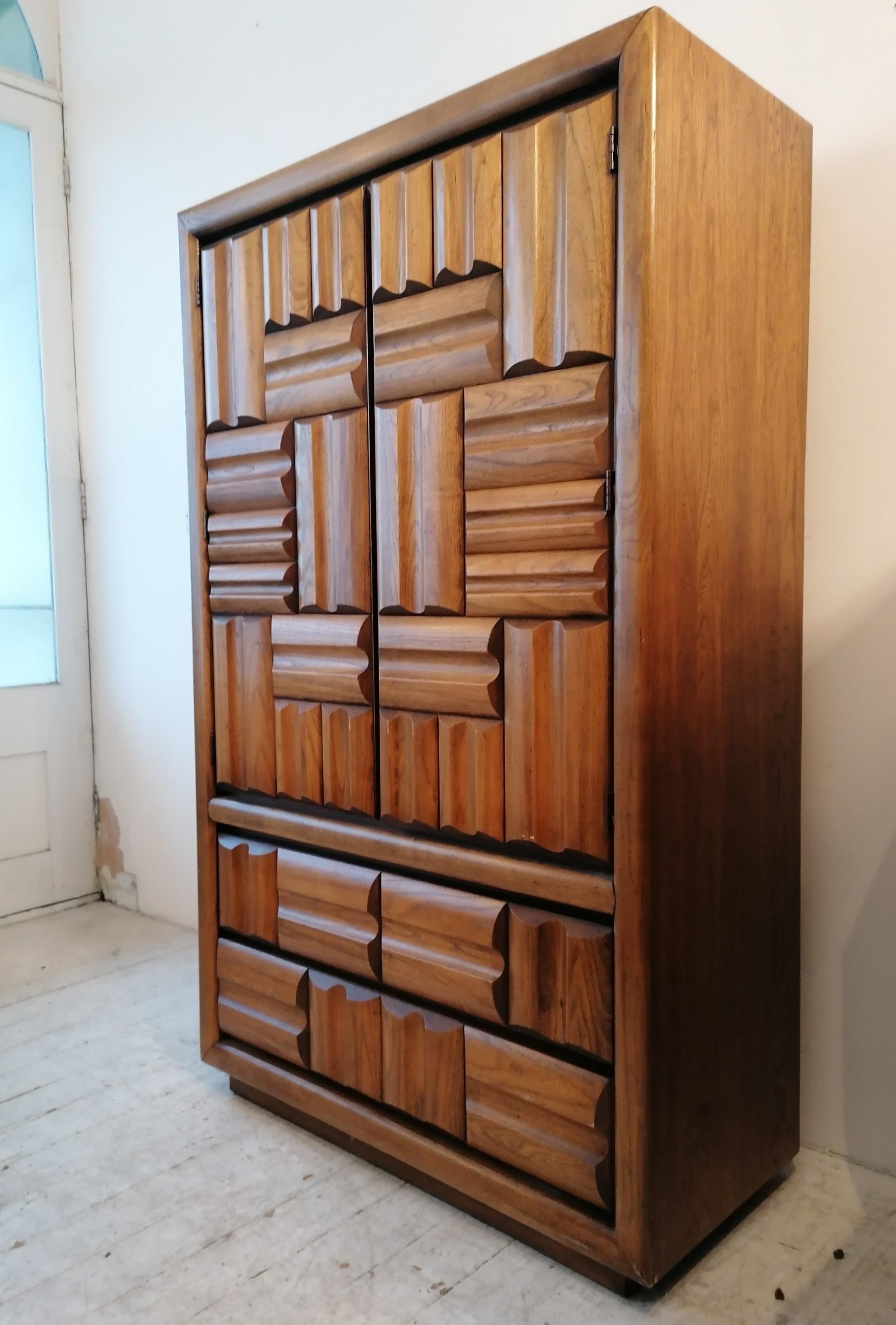 A spectacular, huge Brutalist cabinet by Lane Furniture, USA 1970s. Drawer and door fronts have a chunky, sculpted brutalist design in relief.
Two doors on the upper part open to 2 internal drawers and adjustable shelves. Below are 2 large