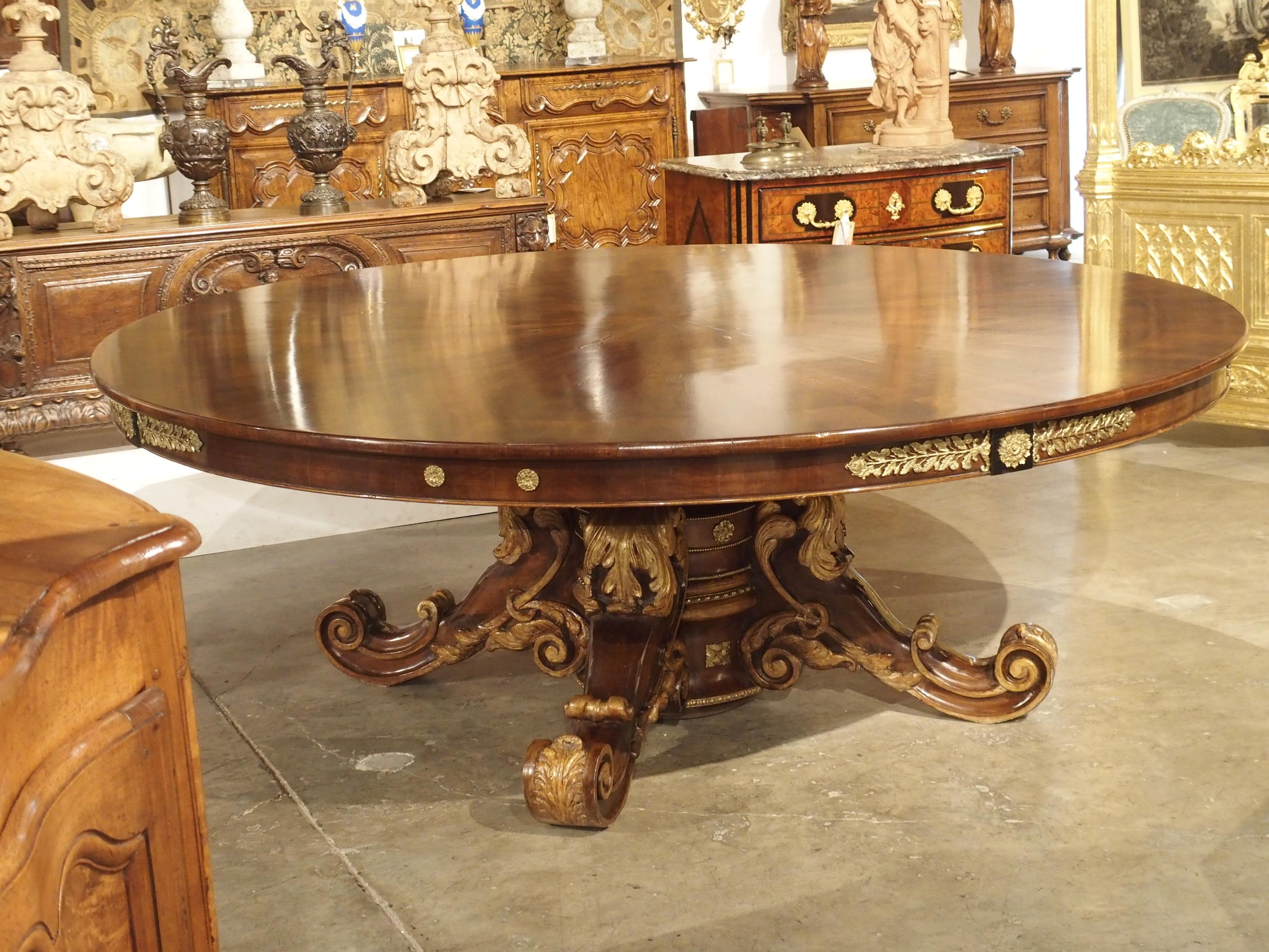 Made from walnut wood, walnut veneer and bronze doré embellishments, this large round table was produced in France at the end of the Restoration period, circa 1830.

The Bourbon Restoration is the 15-year period of recovery following the defeat of