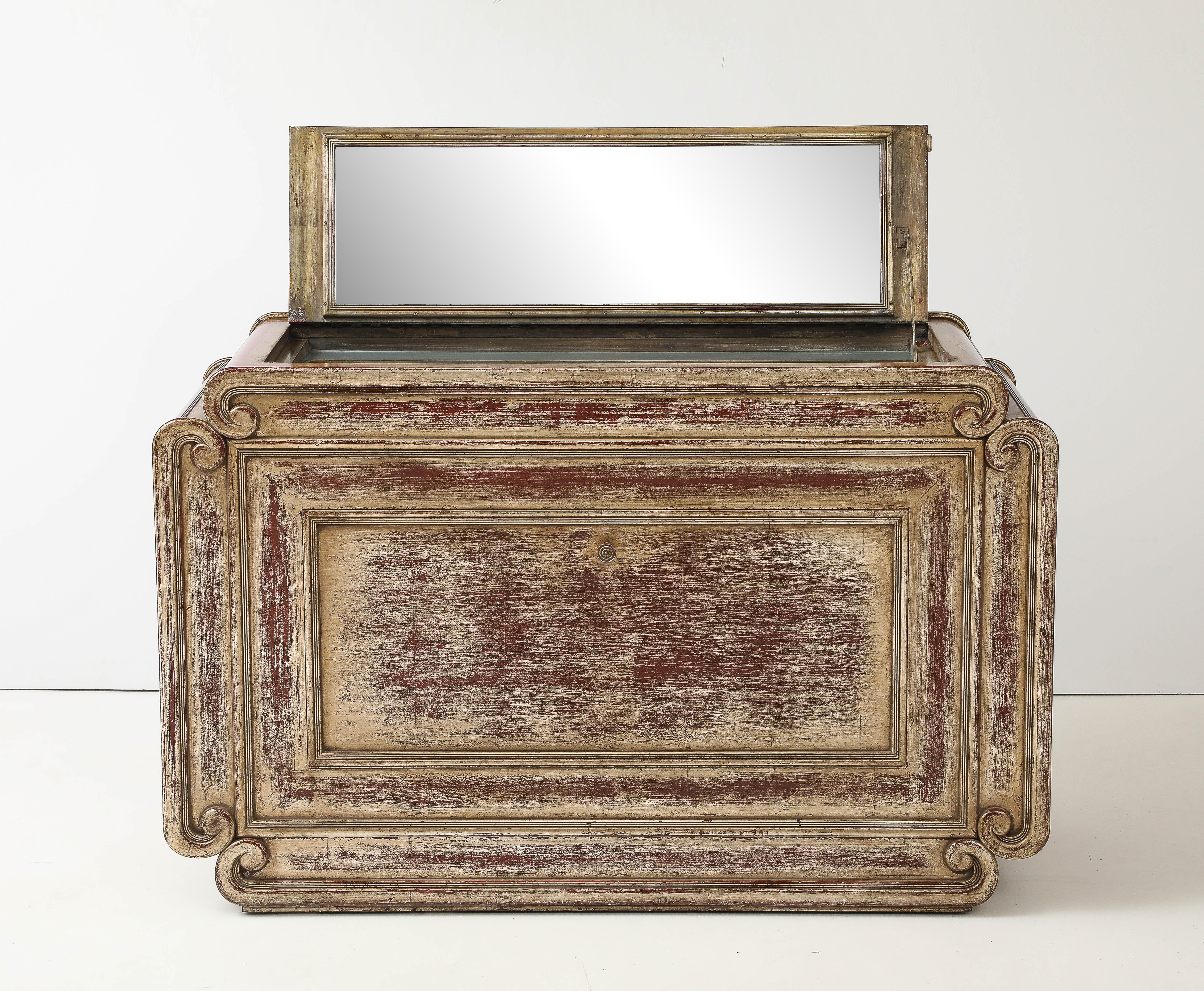 Espectacular armario con el acabado original en pan de plata envejecido de James Mont.
El mueble, de bella ejecución, con detalles de roleos y molduras de cuadros, tiene el acabado original Mont 
con el Rojo sangrando a través de la Hoja de plata