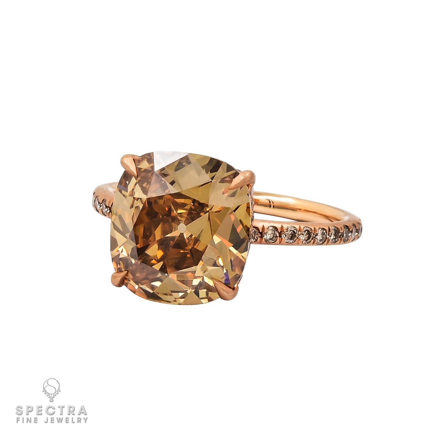 Nothing captivates quite like the brilliance of a diamond, especially one with a rich, unique hue. This diamond engagement ring, crafted in 18K rose gold, features a stunning 4.08-carat cushion-shaped Fancy Deep Brown-Yellow diamond, as certified by