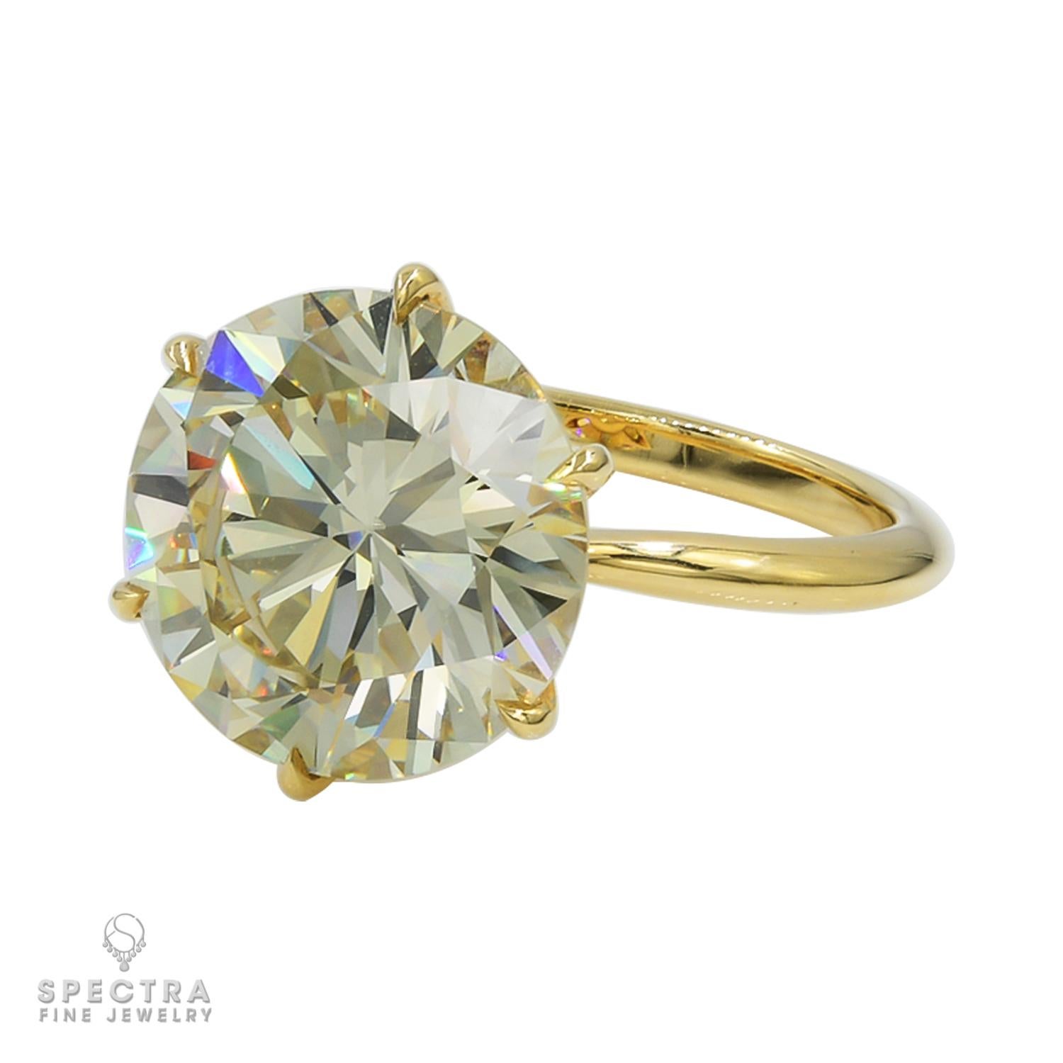 A stunning engagement ring featuring a 5.55 carat round diamond mounted in 18k yellow gold. 
The color of the diamond is Y-Z, it is not certified.
Weight of the ring is 3.91 grams.
Size 6. Resizing available.