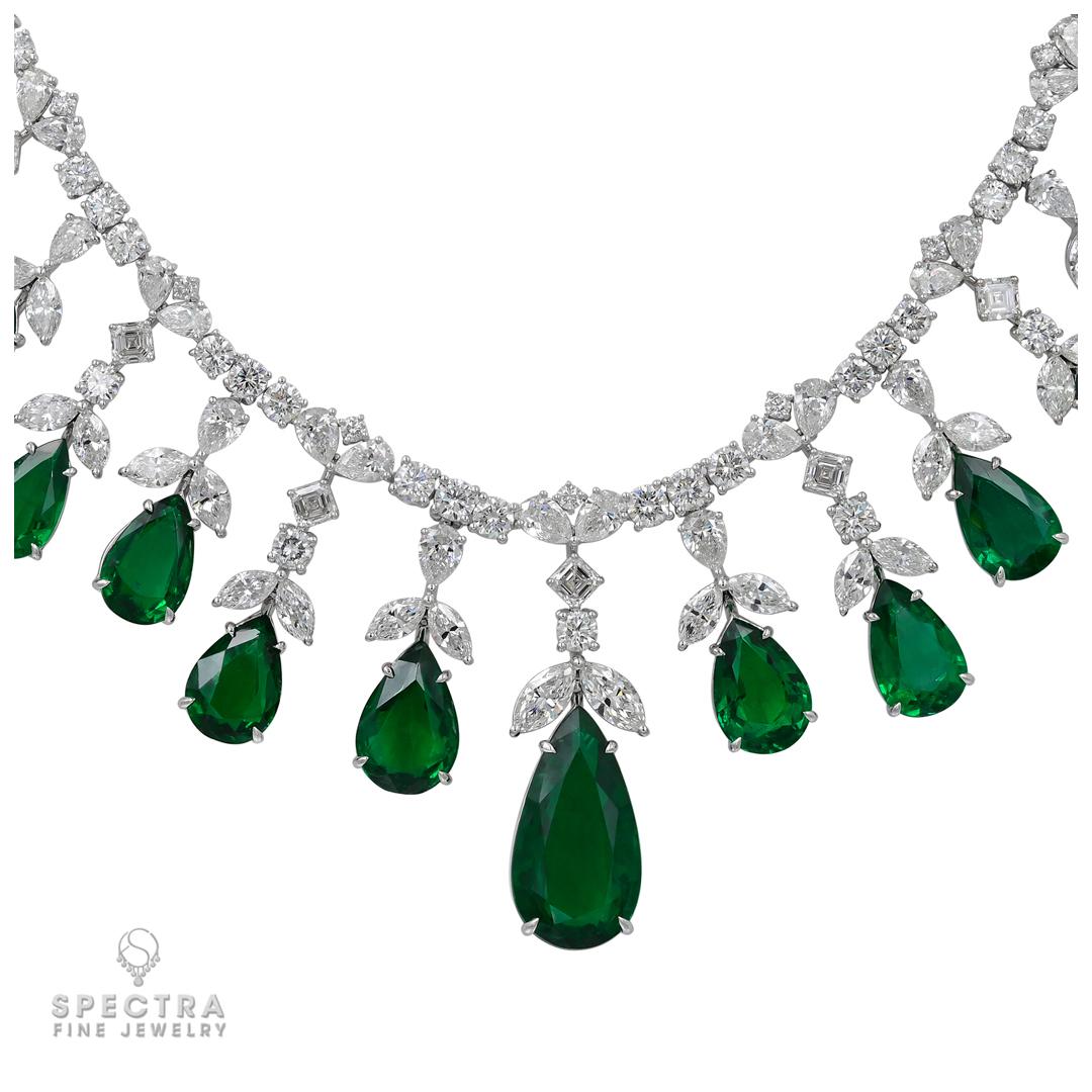 Elevate your elegance with this exclusive 57.37ct Pear-Shaped Zambian Emerald and Diamond Fringe Necklace, expertly crafted by Spectra Fine Jewelry. This captivating masterpiece showcases 17 dazzling pear-shaped emeralds accented by brilliant