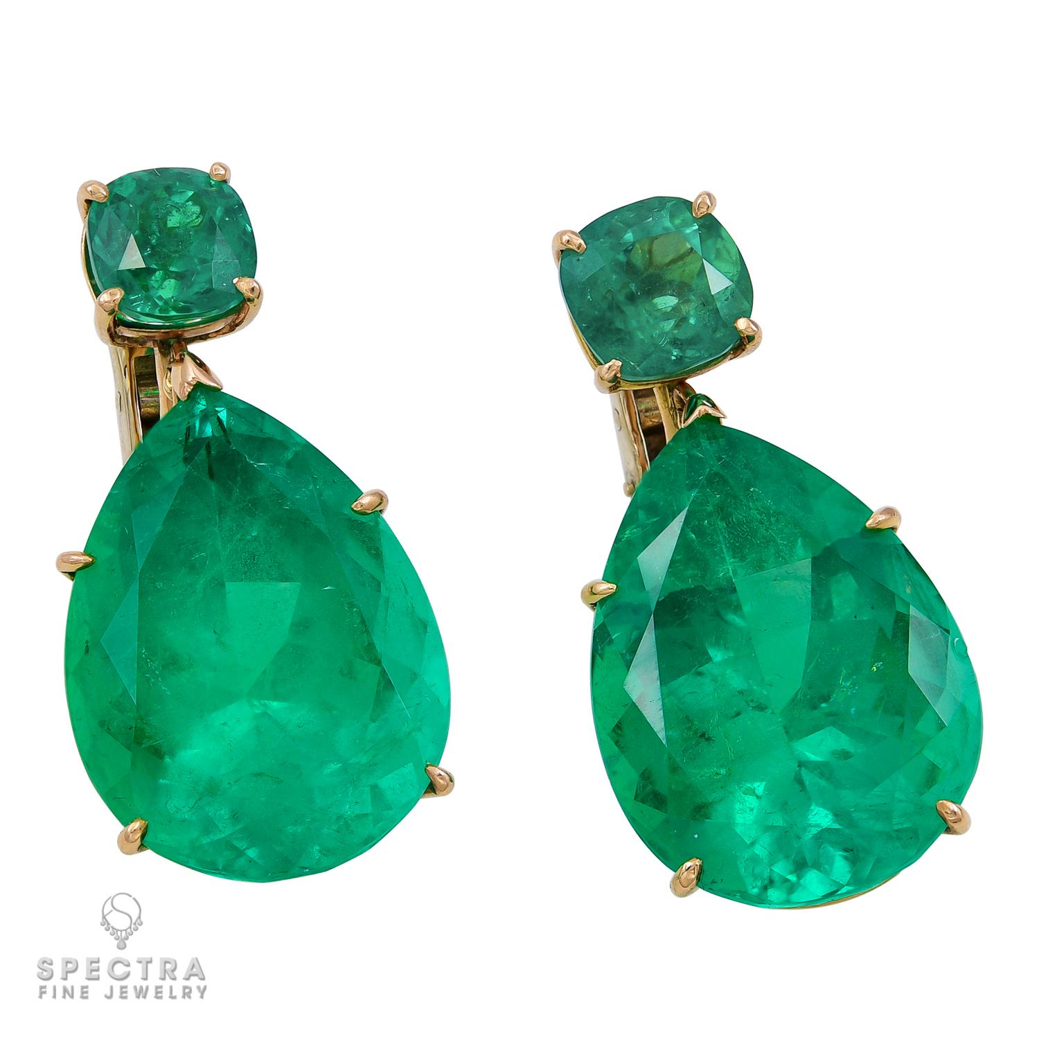 Introducing our stunning pair of drop earrings featuring four breathtaking Colombian emeralds. These earrings are a true statement piece with a total weight of approximately 59 carats. The top of the earrings are adorned with two cushion-shaped