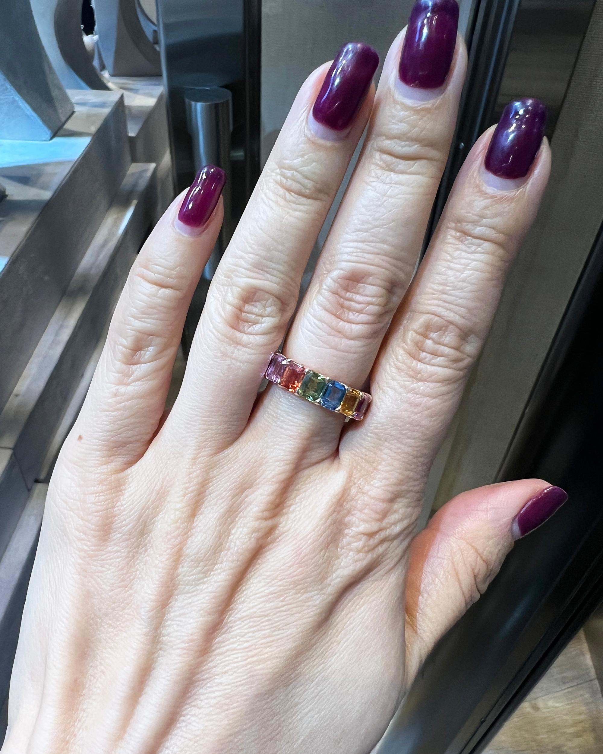 A stylish eternity band comprising of 17 all natural emerald-cut multicolored sapphires weighing a total of 9.34 carats. The weight of each stone is 0.55 carat.
Metal is 18k rose gold, gross weight 6.18 grams.
Size of the ring is 6.5. Not sizable.