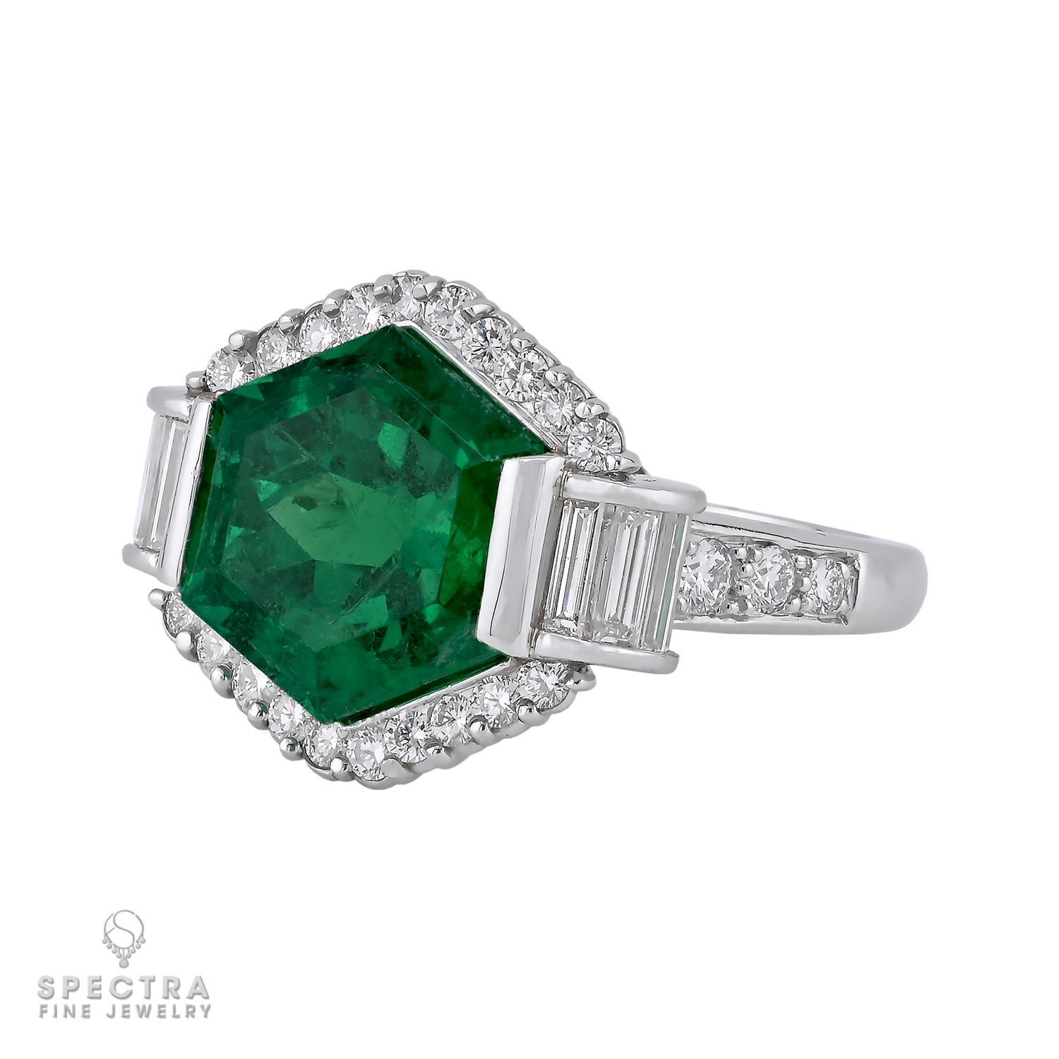 Indulge in elegance with this captivating Colombian emerald and diamond cocktail ring, crafted in platinum. Showcasing a stunning 7.05-carat hexagonal Colombian emerald, this vibrant, natural gem (with minor oil for clarity enhancement) glows with