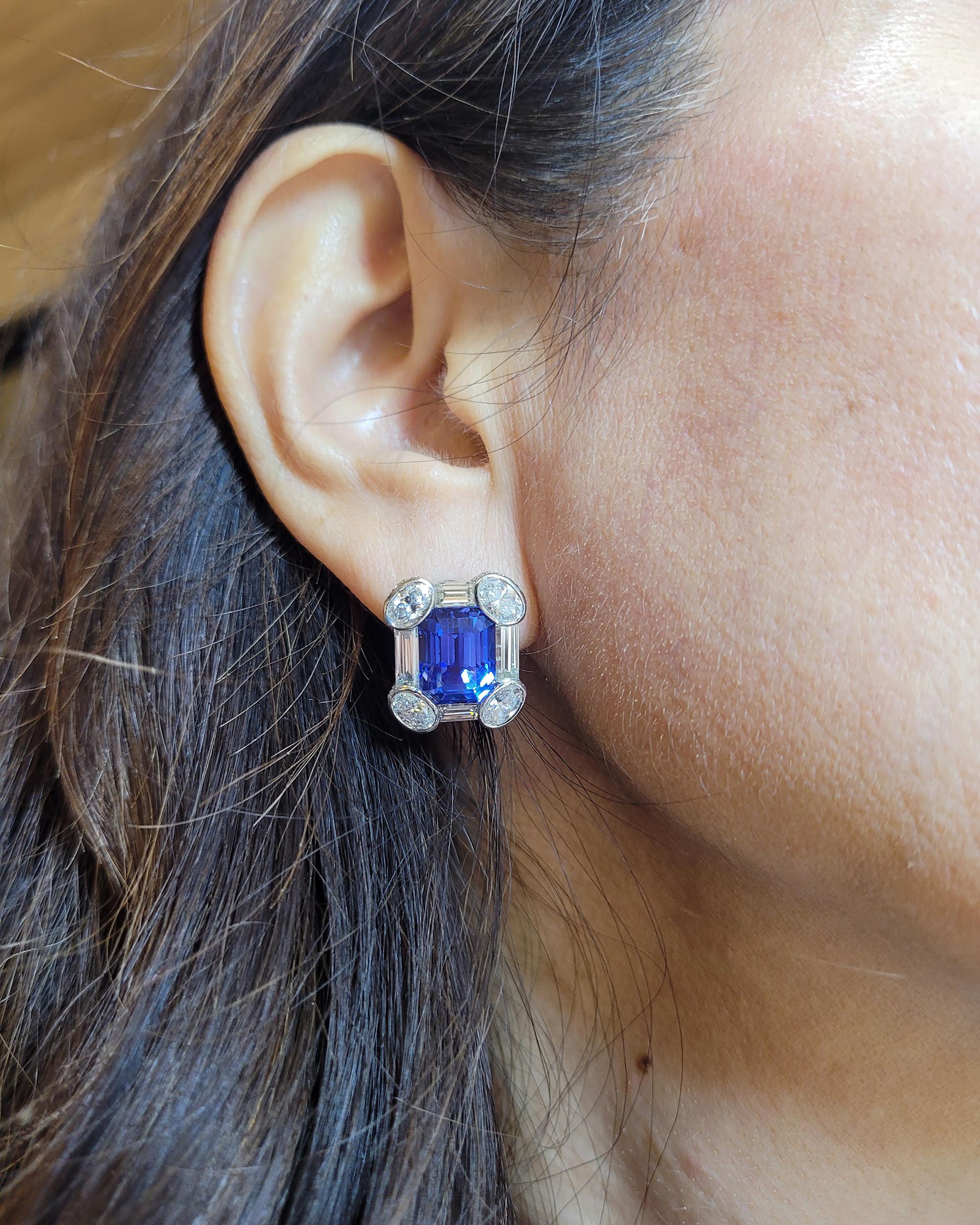 A stunning pair of earrings set with two rectangular-cut sapphires within a baguette and oval-cut diamond surround, to the pavé-set diamond sides. Mounted in platinum.
Accompanied by report from the AGL (American Gemological Laboratories), stating