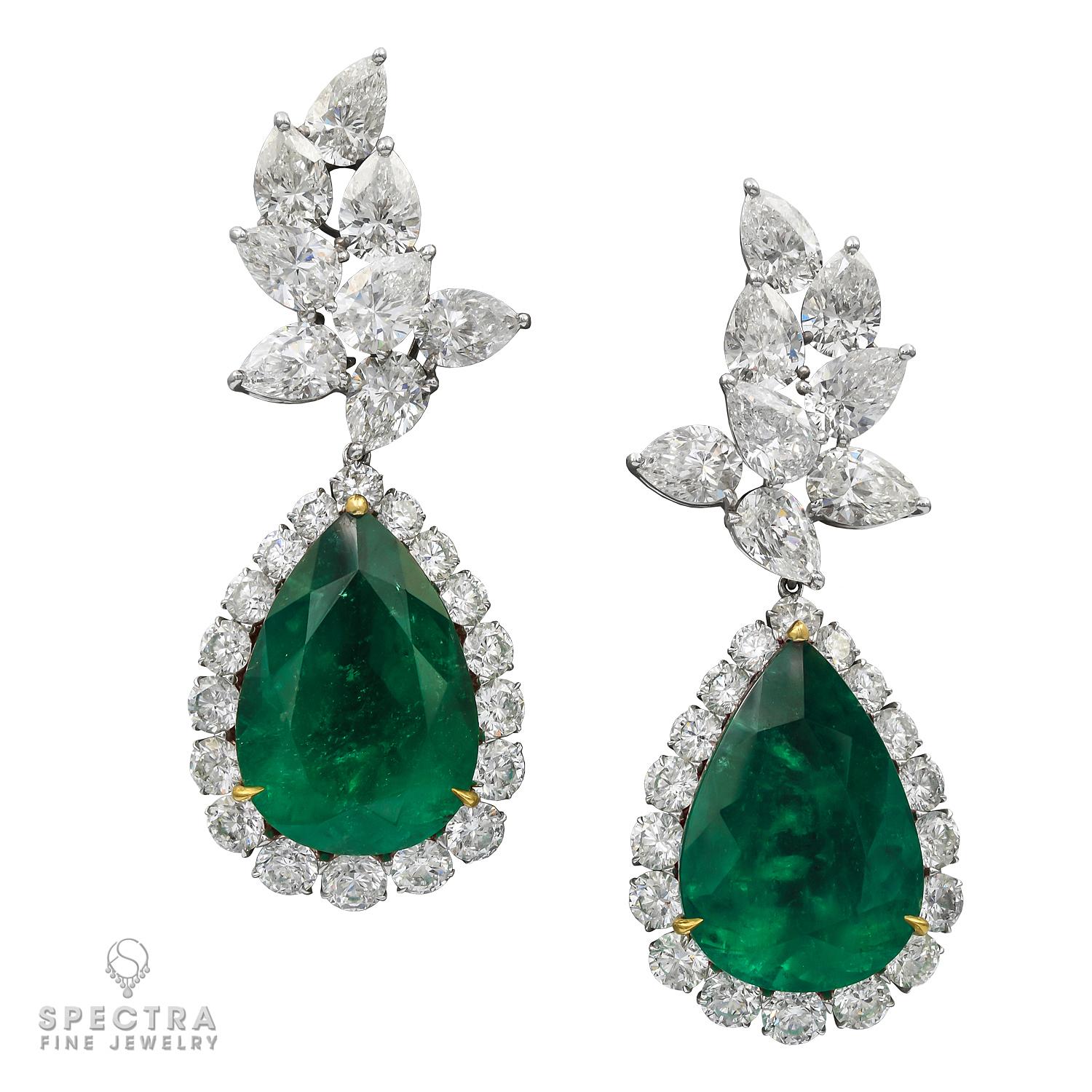 A beautiful pair of important earrings featuring two pear-shape green emeralds and diamonds.
The emeralds are certified by C. Dunaigre lab, stating that the weight of each is 22.23 carats and 24.84 carats, Colombian with minor clarity enhancement.