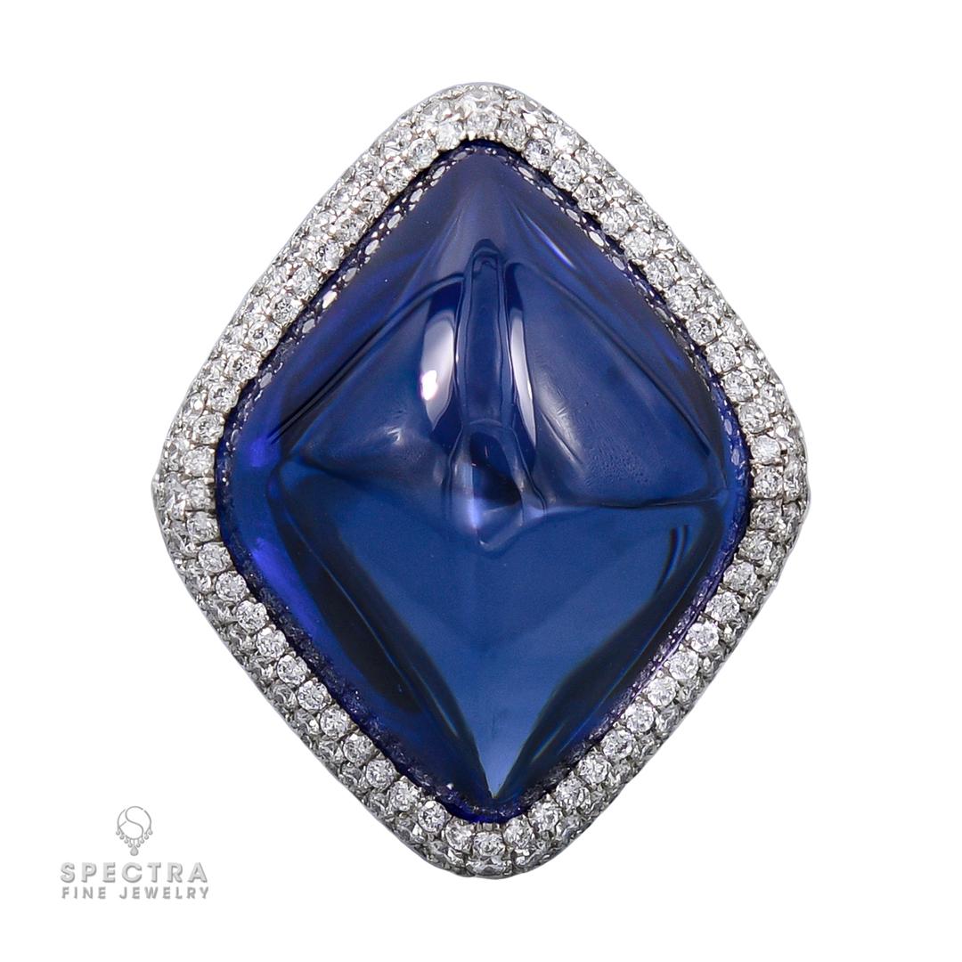 A unique sugarloaf shape natural sapphire weighing 38.53 carats and set in a halo, encrusted with pave diamonds.
The sapphire is certified by C.Dunaigre and GGTL Laboratories stating that it is of Sri-Lankan origin with the indications of heat. 
The