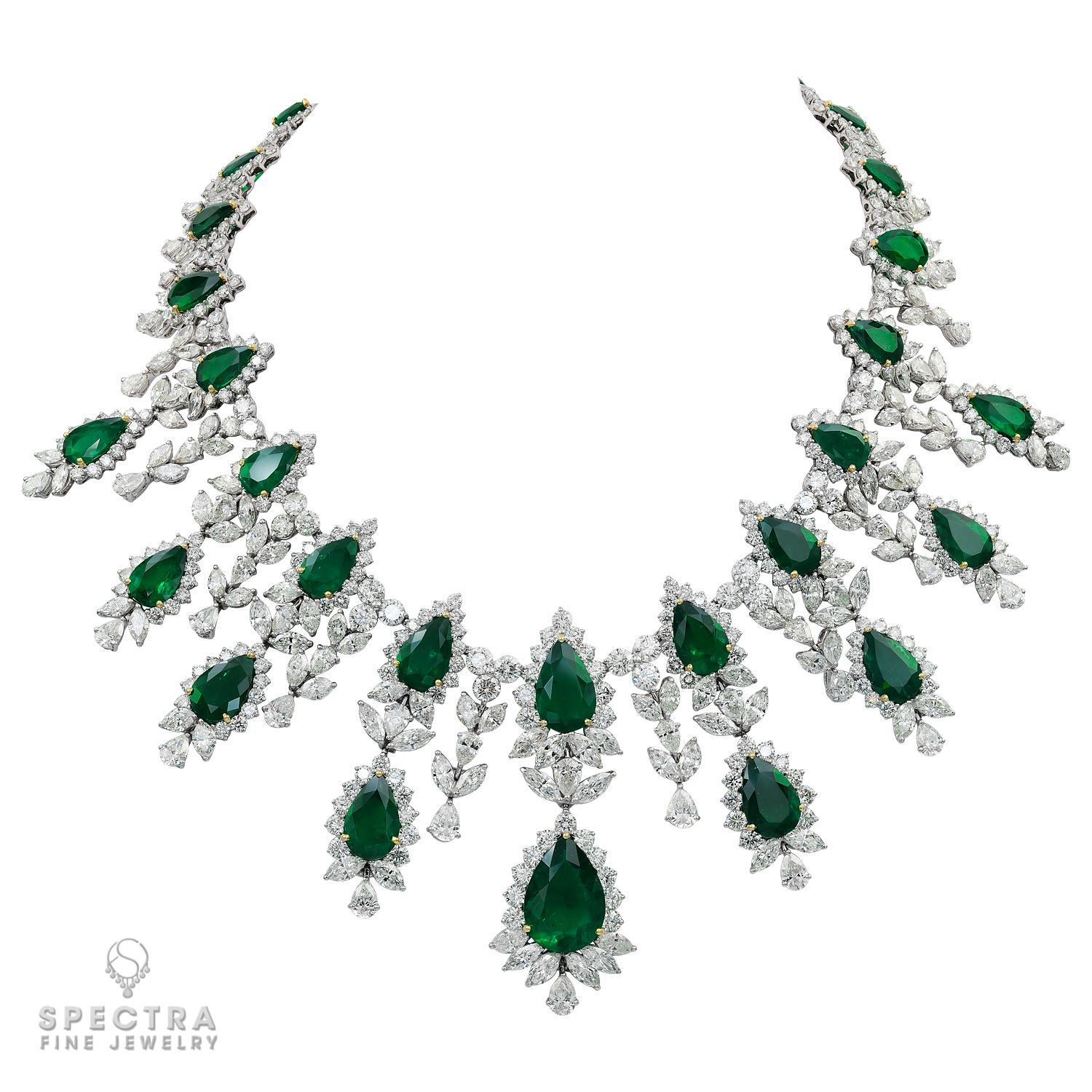This exquisite Spectra Fine Jewelry Colombian Emerald Demi Parure Suite, made in the Contemporary era, circa 2010s, is comprised of two related yet distinctive piece, featuring a bib necklace with nine pendants and equally dramatic drop earrings.