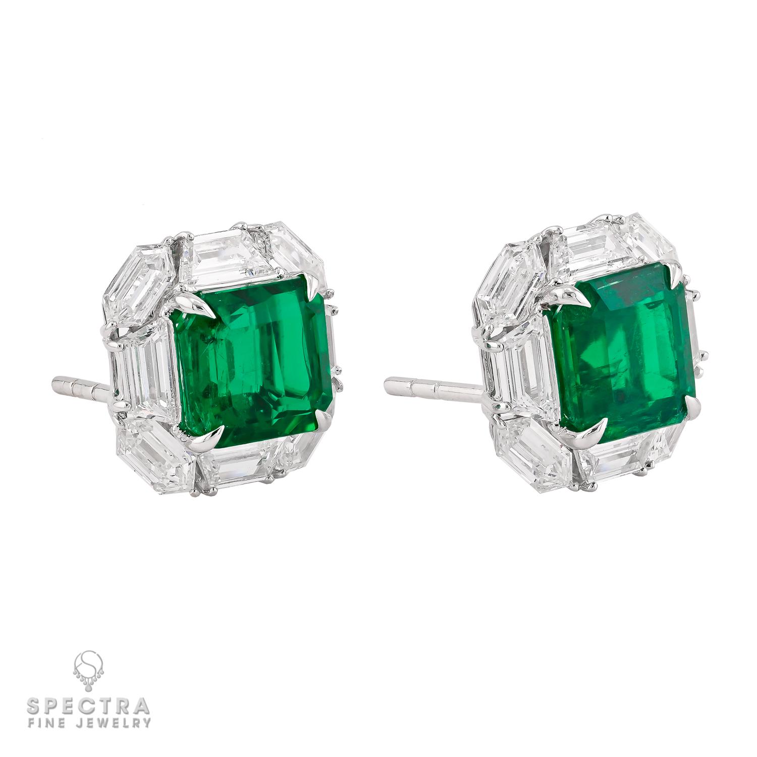 A captivating blend of timeless elegance and refined craftsmanship, these Colombian emerald diamond stud earrings are truly exquisite. Featuring a perfectly matched pair of emerald-cut green emeralds weighing 2.06 and 2.12 carats, their rich,