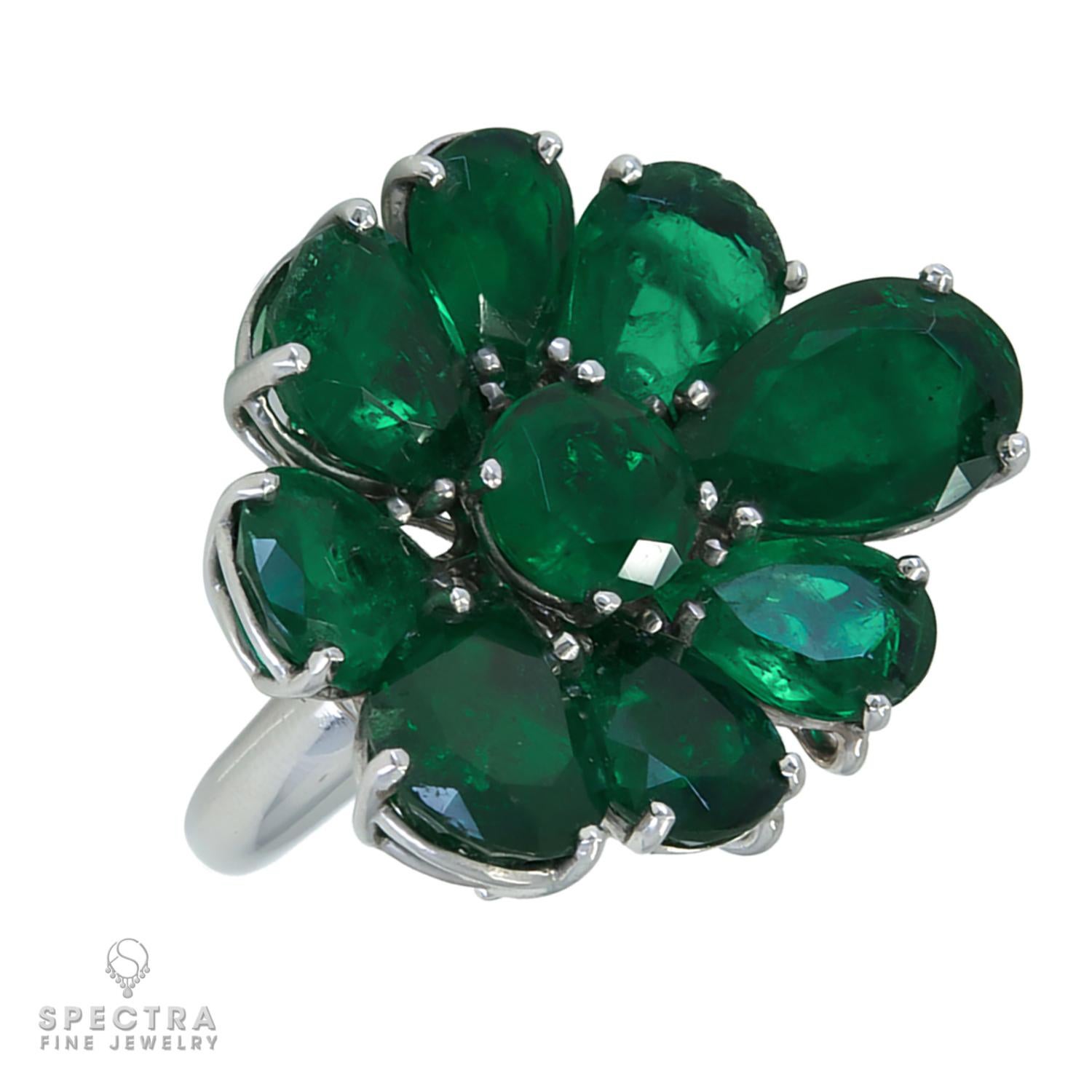 This Spectra Fine Jewelry Colombian Emerald Convertible Flower Ring and Pendant, made in the Contemporary Era, circa 2010s, features 9 Colombian emeralds including 8 pear-shape and 1 round, weighing approximately 17.32 carats total. The eight petals