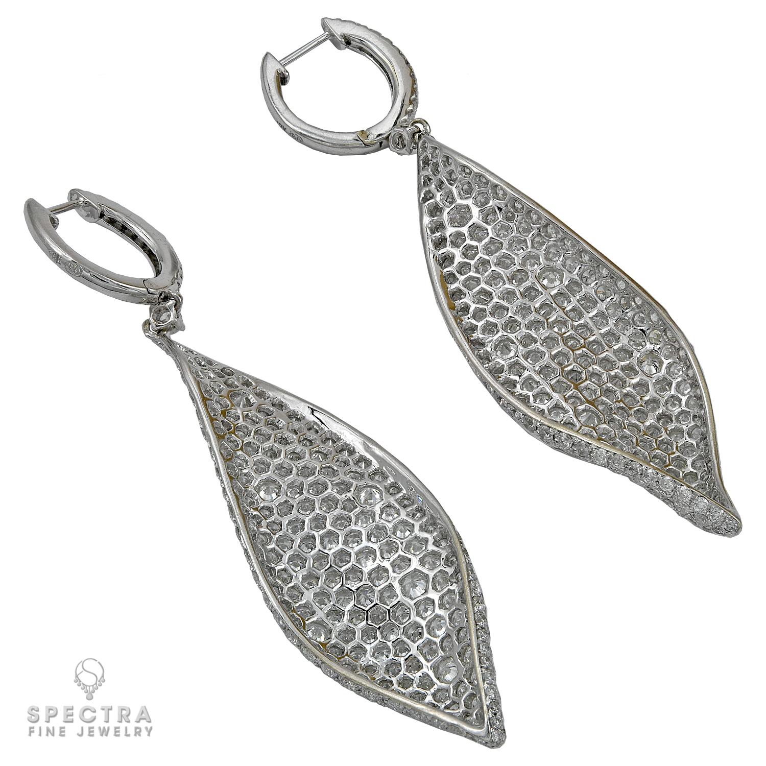 The splendid sparkling surface defines the sculptural shape of these distinctive Diamond Leaf Earrings from Spectra Fine Jewelry. Crafted in 18K white gold, the mirror image pair is embellished with round brilliant-cut diamonds all over in a pavé