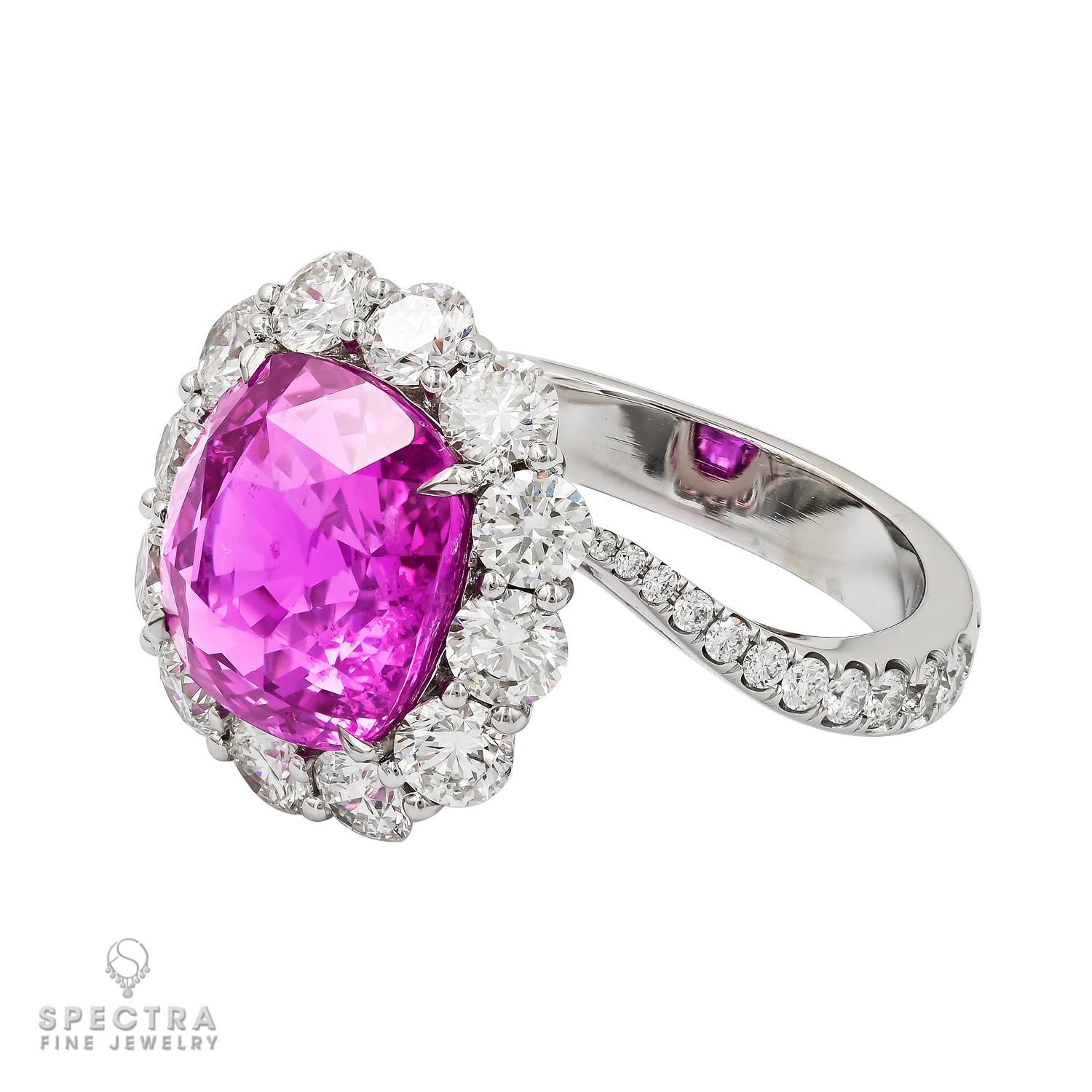 Elevate your jewelry collection with the enchanting beauty of this 7.08 carat Cushion Pink Sapphire Ring. Originating from Madagascar and boasting an unheated, natural allure, the centerpiece of this ring is a breathtaking 7.08 carat cushion-cut