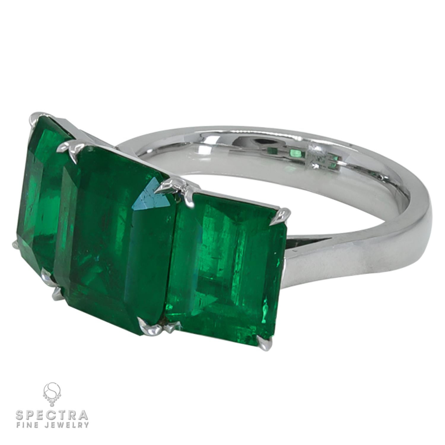 A beautiful ring embellished with three step-cut emeralds mounted in 18K white gold.
Total weight of the emeralds is 6.52 carats.
The emeralds are certified by GRS lab, stating that they are Colombian with minor clarity enhancement. 
Two vividly