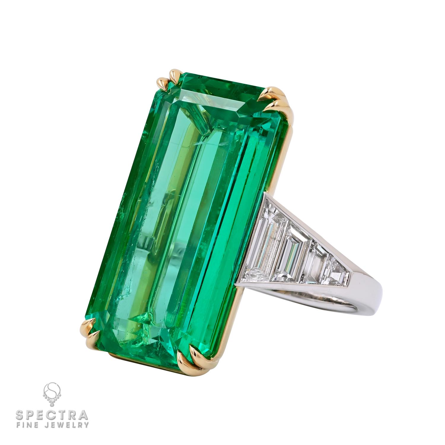 Envision yourself adorned in the breathtaking allure of this remarkable Colombian Emerald Diamond Ring, a true testament to refined elegance and exceptional craftsmanship. At its heart lies a mesmerizing elongated octagon-shaped emerald of Colombian