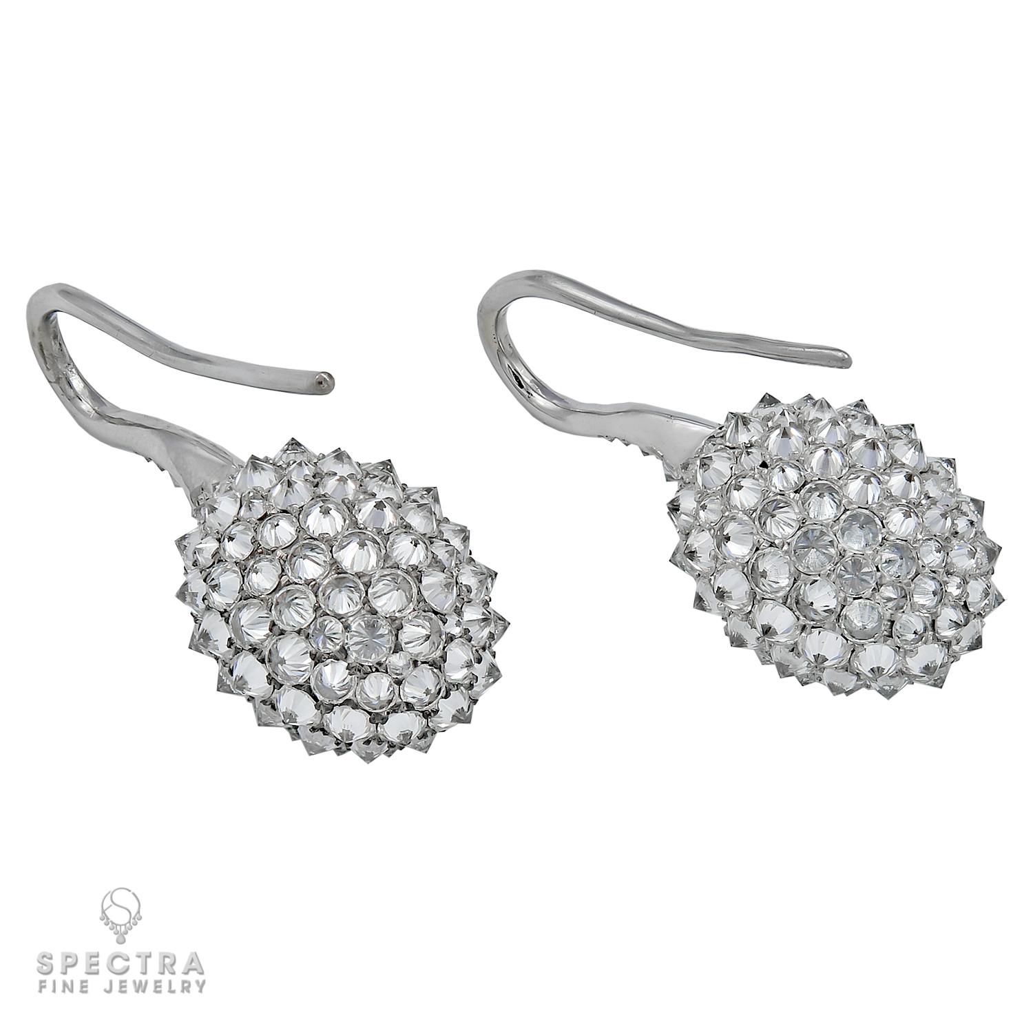 Unique earrings comprising of two oval center diamonds weighing 0.75 carat and 0.78 carat with F-G color, VVS-VS clarity. Not certified. 
The center stones are surrounded by a halo of round diamonds and three circles of inversely-set diamonds.