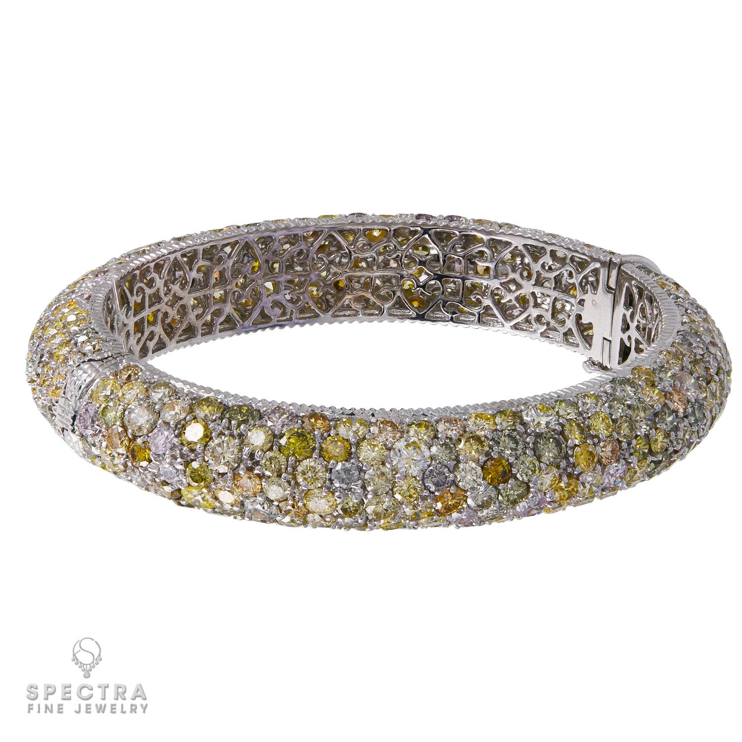Multicolored diamonds can have an ethereal quality that is extremely delicate and light in a way that is too perfect for this world. This Contemporary Multicolor Diamond Pavé Bombé Bangle Bracelet, made by Spectra Fine Jewelry in 2021, is crafted in