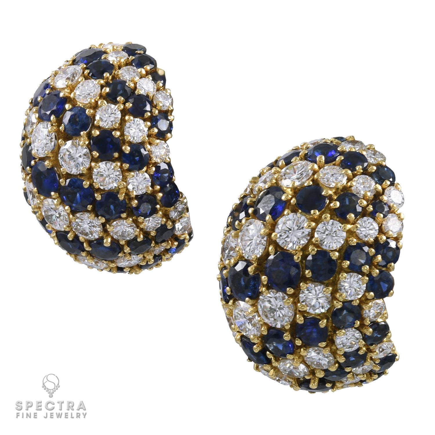 This symmetrical mirror image pair of Sapphire and Diamond Bombé Button Earrings made in the Contemporary era, 21st century, are crafted in 18K yellow gold, and feature diagonal stripes of round brilliant-cut blue sapphires with an estimated weight