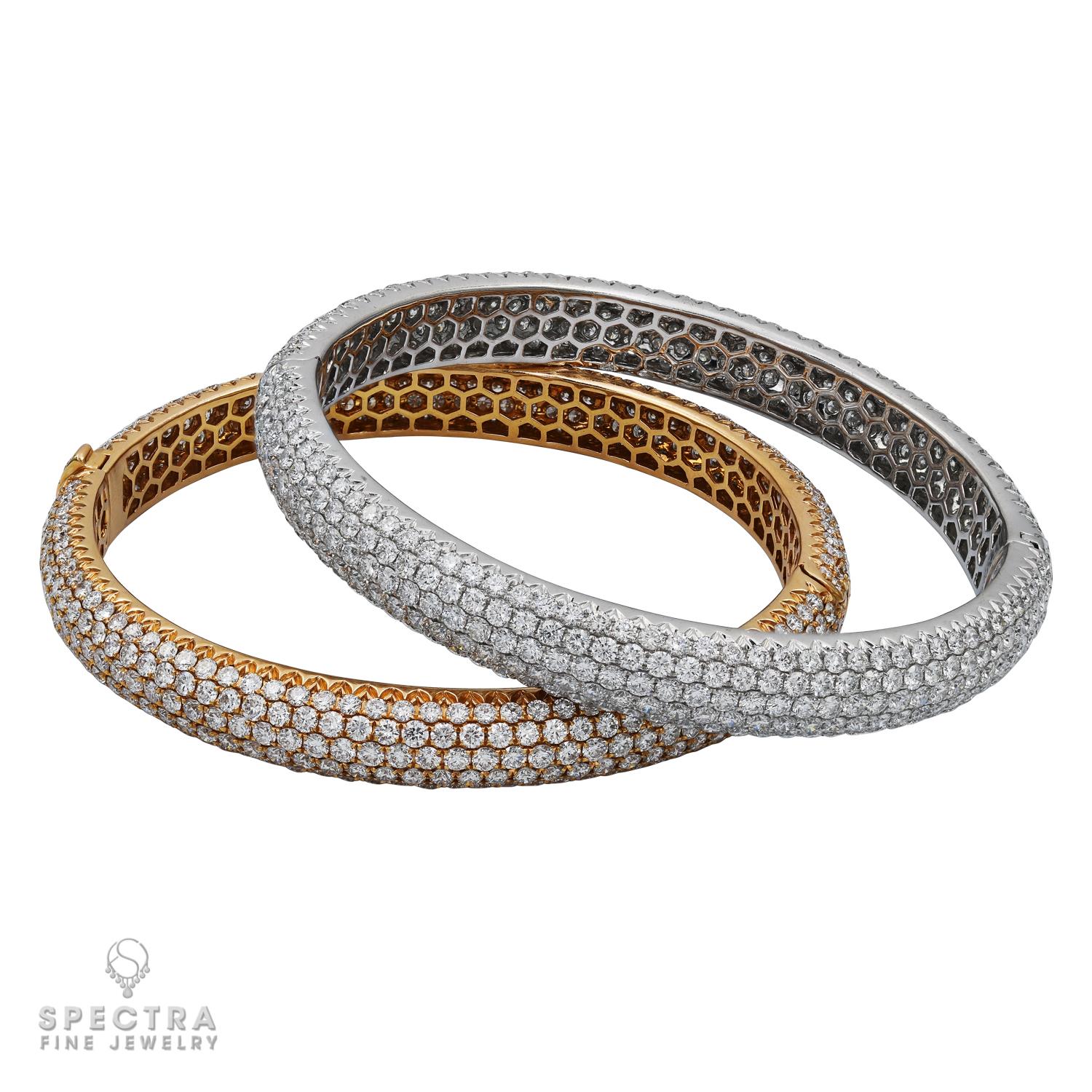 A set of two pavé-set circular-cut diamond bangles, 2 1/4 ins. diameter, mounted in 18k white and rose gold.
Diamonds in a rose gold bangle weigh a total of 12.77 carats.
Diamonds in a white gold bangle weigh a total of 13.21 carats.
Diamonds are