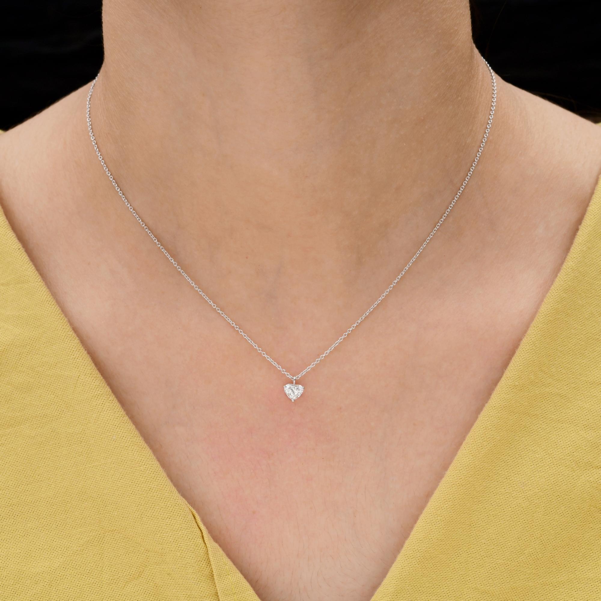 Ce collier solitaire en or blanc 18 carats à diamant en forme de cœur naturel présente une chaîne délicate. En son centre se trouve un brillant diamant taillé en cœur, solidement serti dans une monture minimaliste à trois branches.
Les diamants sont