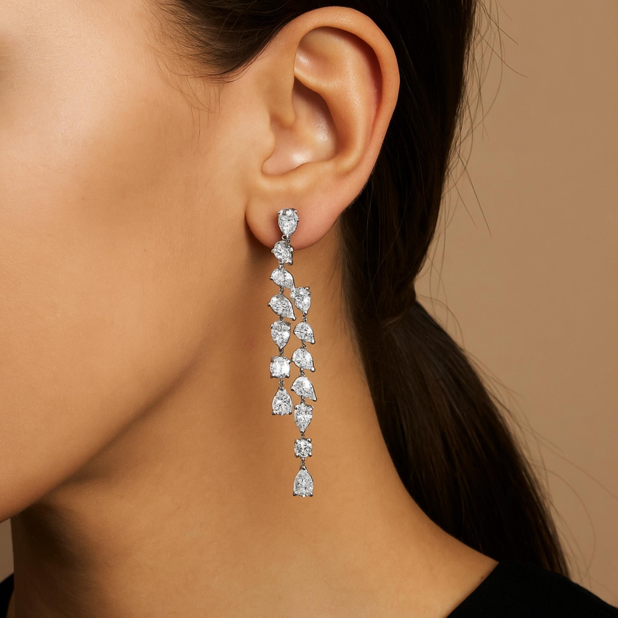 Orecchini da sposa a goccia con diamanti a forma multipla 9.41Ct SI/H in oro bianco 14k. 
Questi orecchini presentano una squisita cascata di gemme a forma di pera e di taglio rotondo, intricatamente incastonate per creare una silhouette fluida e