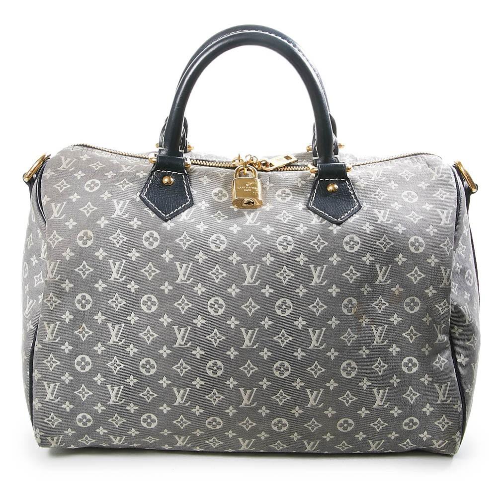 Pre owned Louis Vuitton bag Monogram Idylle from 2012, made of grey fabric and dark blue leather. Gold jewellery. The inner lining made of blue fabric is in good condition. 2 flat pockets inside. Included : handle and padlocks (no key).  Made in