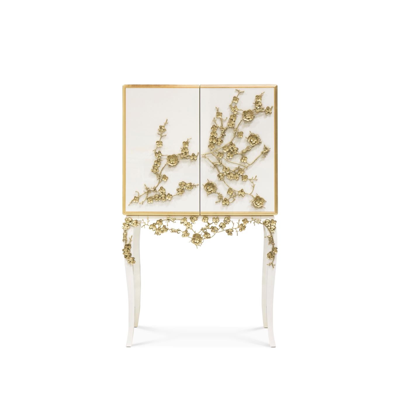 There is a sense of reveal and conceal as KOKET takes a beautiful bar cabinet in high gloss lacquer and adorns it in metal organic lace, revealing a mesmerizing hint of what lies beneath. The chic interior is perfectly designed to store your wine