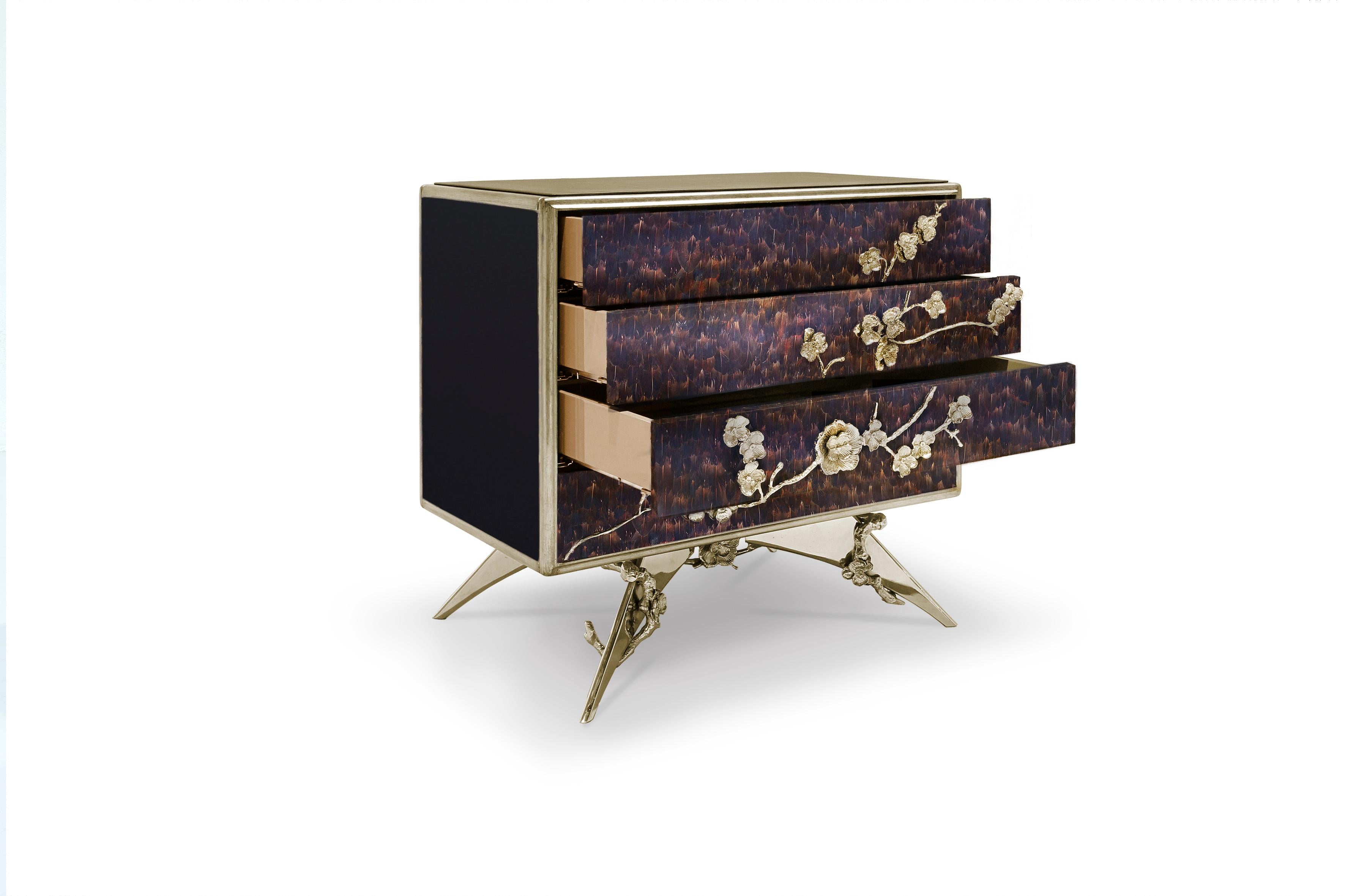 There is a sense of reveal and conceal as KOKET takes a beautiful nightstand in high gloss lacquer and adorns it in metal organic lace, revealing a mesmerizing hint of what lies beneath. Four drawers embellished with organic hardware.

Materials &