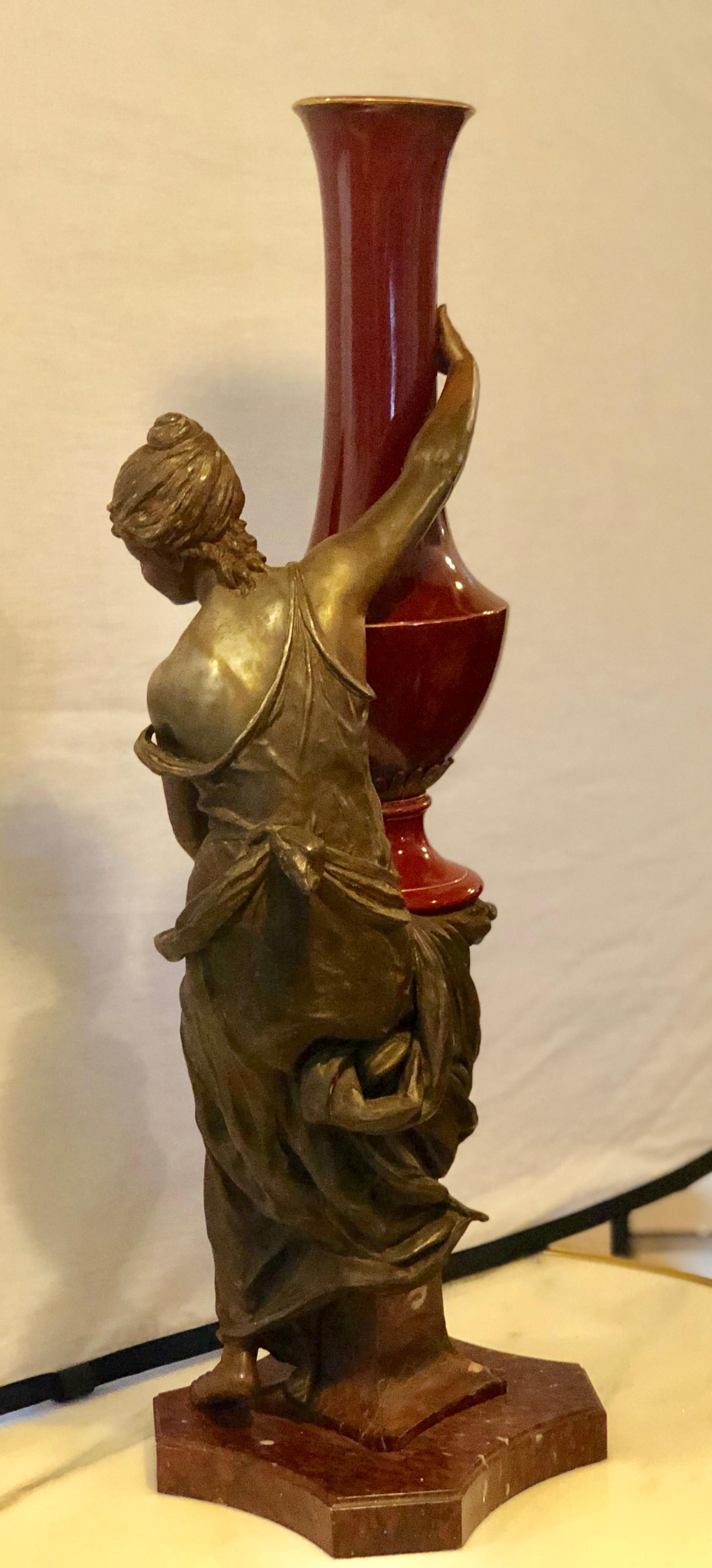20th Century Spelter Figure of a Water Bearer on a Pedestal / Marble with Red Glazed Vase For Sale