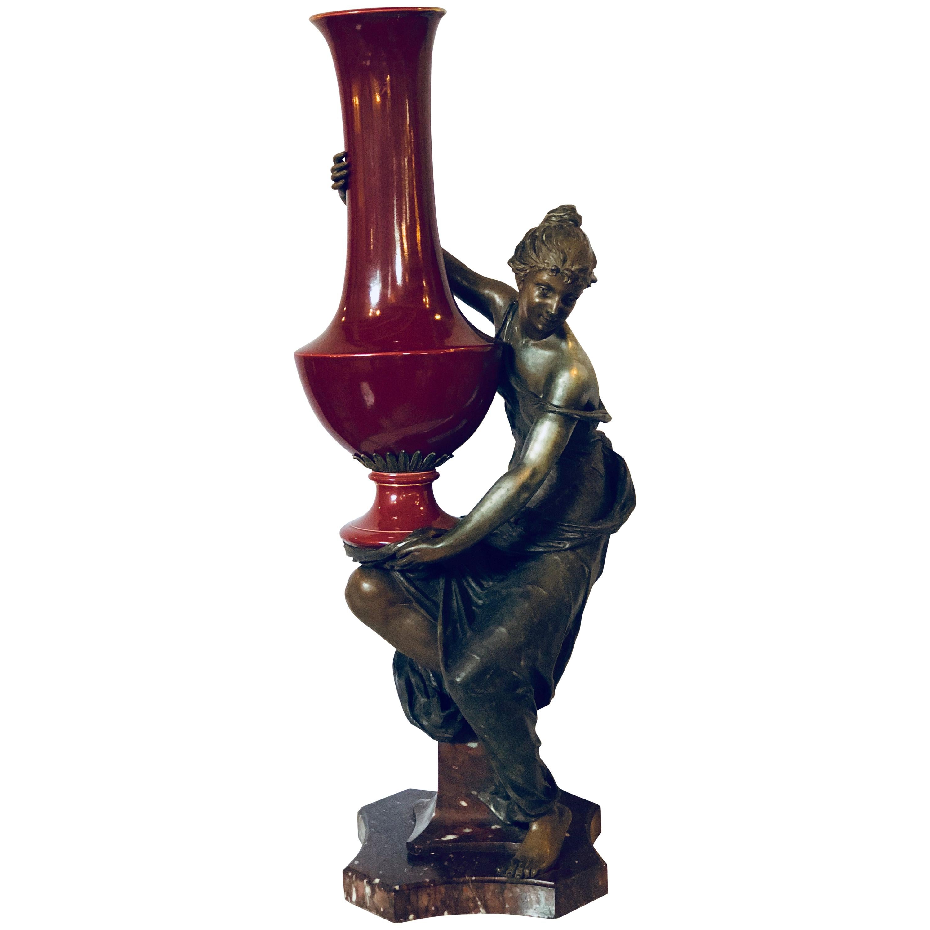 Spelter Figure of a Water Bearer on a Pedestal / Marble with Red Glazed Vase For Sale