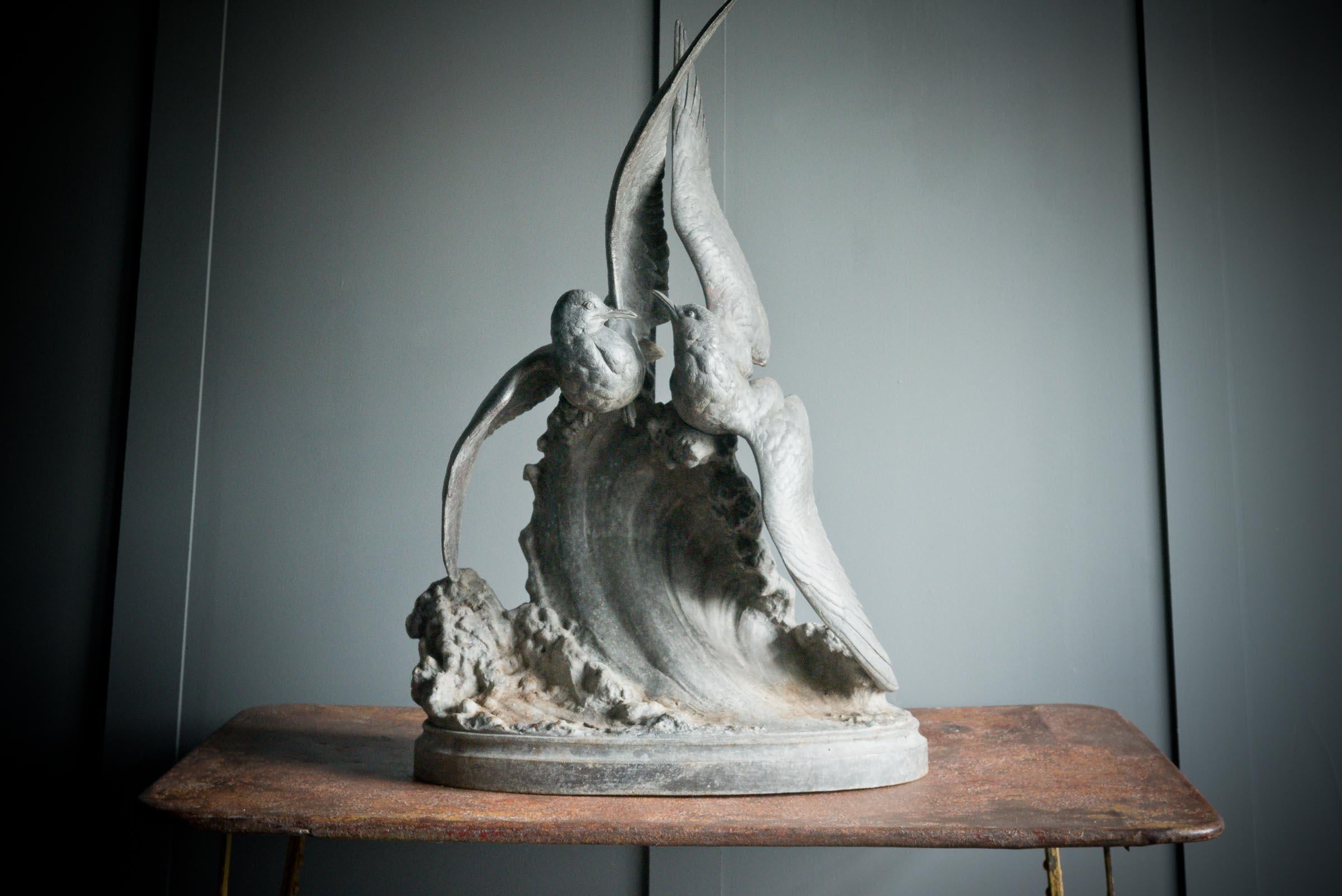 Lovingly sculptured to encapsulate a striking image of two birds with swooping wings out at sea. The birds are sat upon a crashing wave all made from spelter.