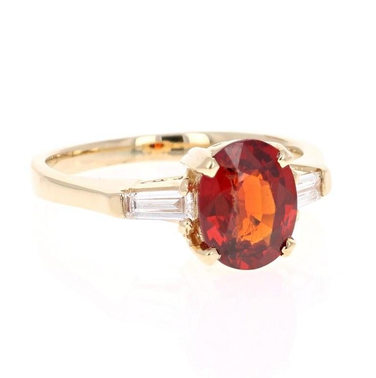 This ring has a 2.57 Carat Oval Cut Spessartine. A Spessartine is a natural stone that is a part of the Garnet family of stones. 
It is embellished with 2 Baguette Cut Diamonds weighing 0.25 Carats. The total carat weight of the ring is 2.72 Carats.