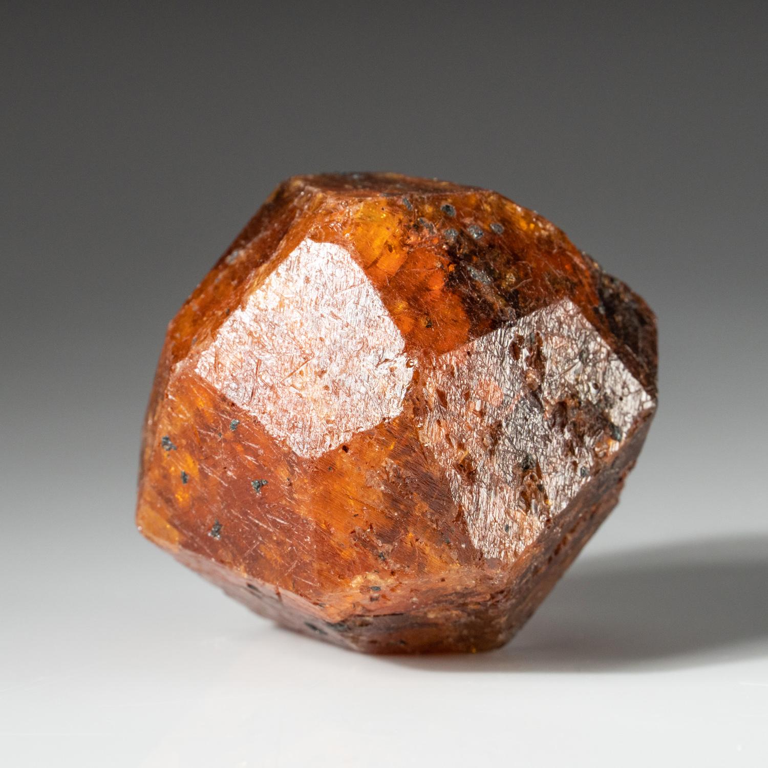 From Nani Hill, Loliondo, Ngorongoro district, Arusha, Tanzania Large trapezohedral crystal of transparent orange spessartine garnet with no matrix attached. Has lustrous faces with well defined edges. 176 grams, 1.75 x 2 x 2 inches It's a beautiful