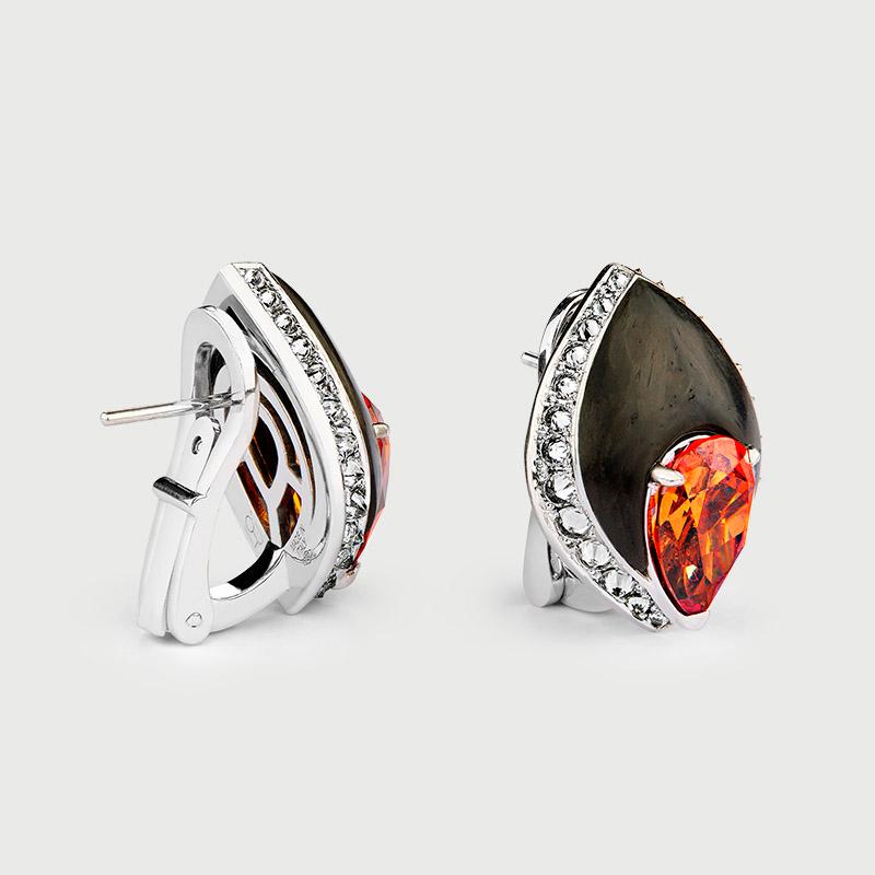 Spessartine Garnet Earrings
Spessartine Garnets: 9.43 carats total weight
Reverse Set Round Brilliant Diamonds: 1.5 carats
18K White Gold 15.5 grams
Earrings handcrafted in 18K White Gold and Carbon Fiber
Gold Weight: 15.5 gram
Made in