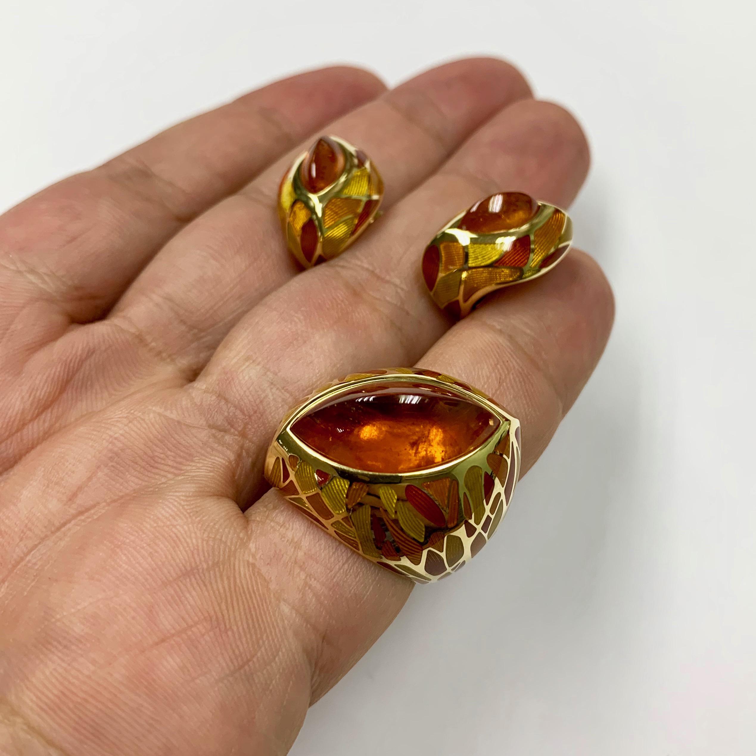 Spessartine Garnet Enamel 18 Karat Yellow Gold Suite

A riot of yellow and orange colors, warm of citrus tea on a rainy autumn day, a smoldering log in the fireplace of a country house, all of this is our stunning Earrings. Take a look at these