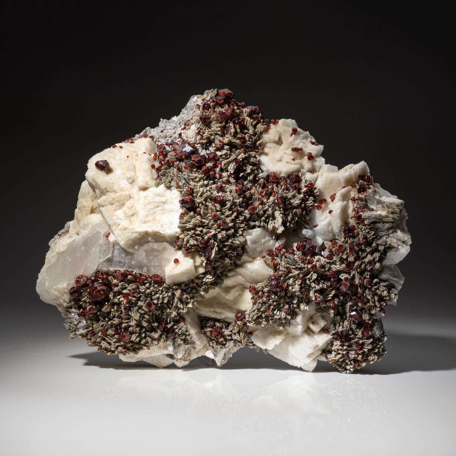 From Tongbei-Yunling District, Fujian Province, China

Cluster of transparent lustrous deep red spessartine garnet cluster on microline matrix with bladed muscovite crystals.

6 lbs, 9 x 2.5 x 8 inches