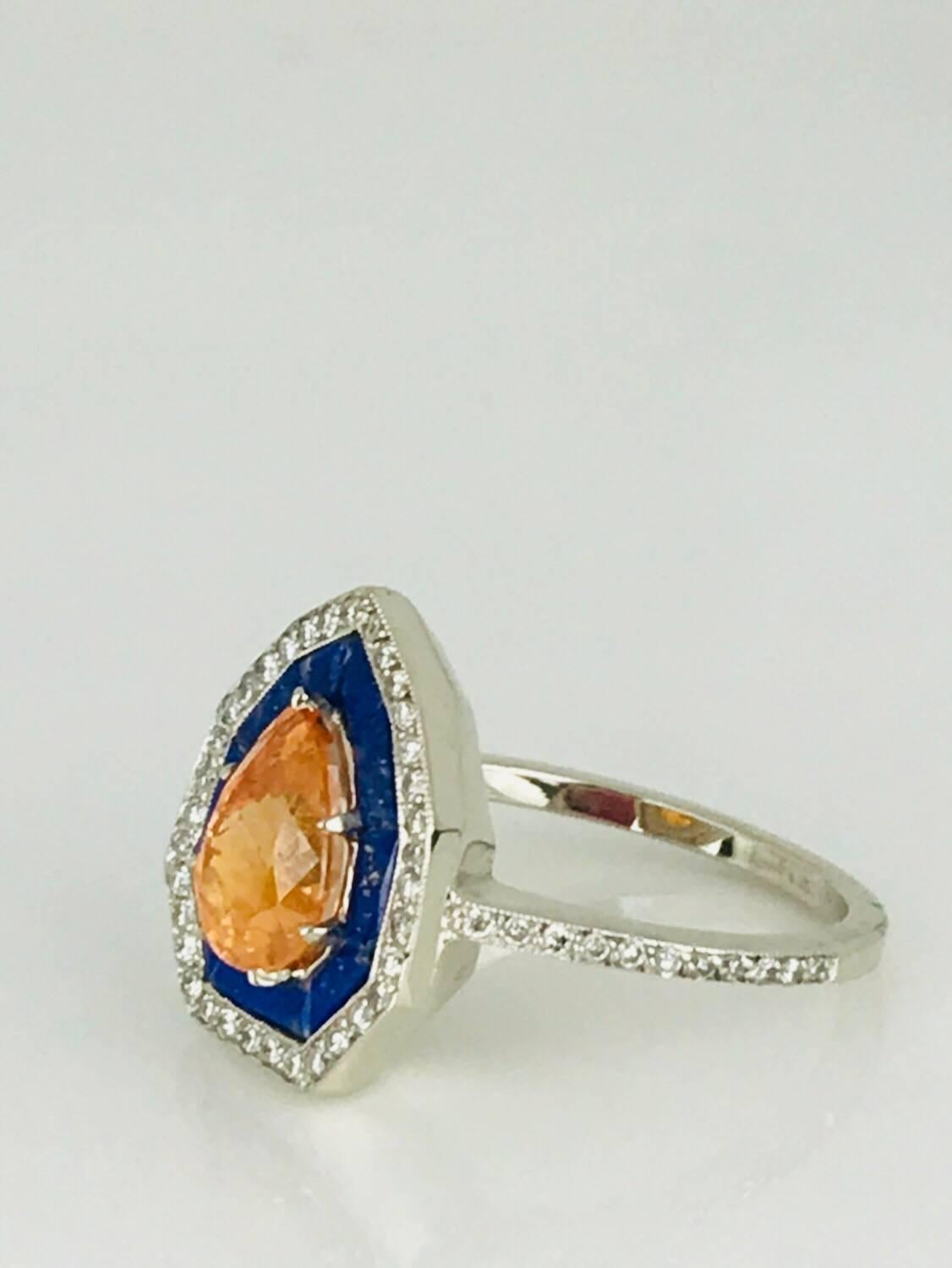 Spessartine Malaia Garnet, beautiful deep colored orange gemstone is center showcase of this halo-style, 14 karat white gold ring. 
Art Deco and high quality the pear shape center stone measures 9.05 x 5.96 x 3.2 millimeters in diameter and  has an