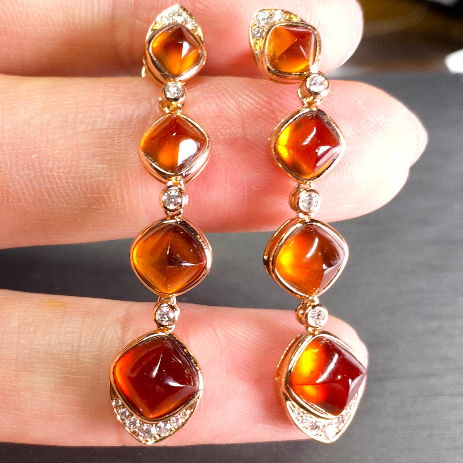 A pair of long chandelier style Spessartite Fanta Garnet and Diamond Earring in 18K Rose Gold. The earring is consist of 4 Spessartite garnet on each side, with top and bottom end encrusted in diamond. The remaining Spessartites are connected by