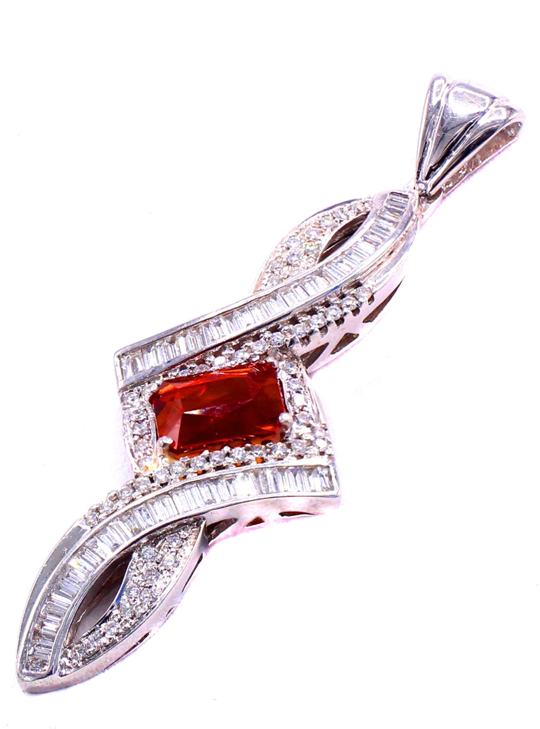 A vibrant orange Spessartite Garnet also known as Mandarin Garnet is the center piece of this beautifully designed pendant. Set in 18 karat white gold the center gem, weighing approximately 3 carats is surrounded by 58 baguette cut and 59 round