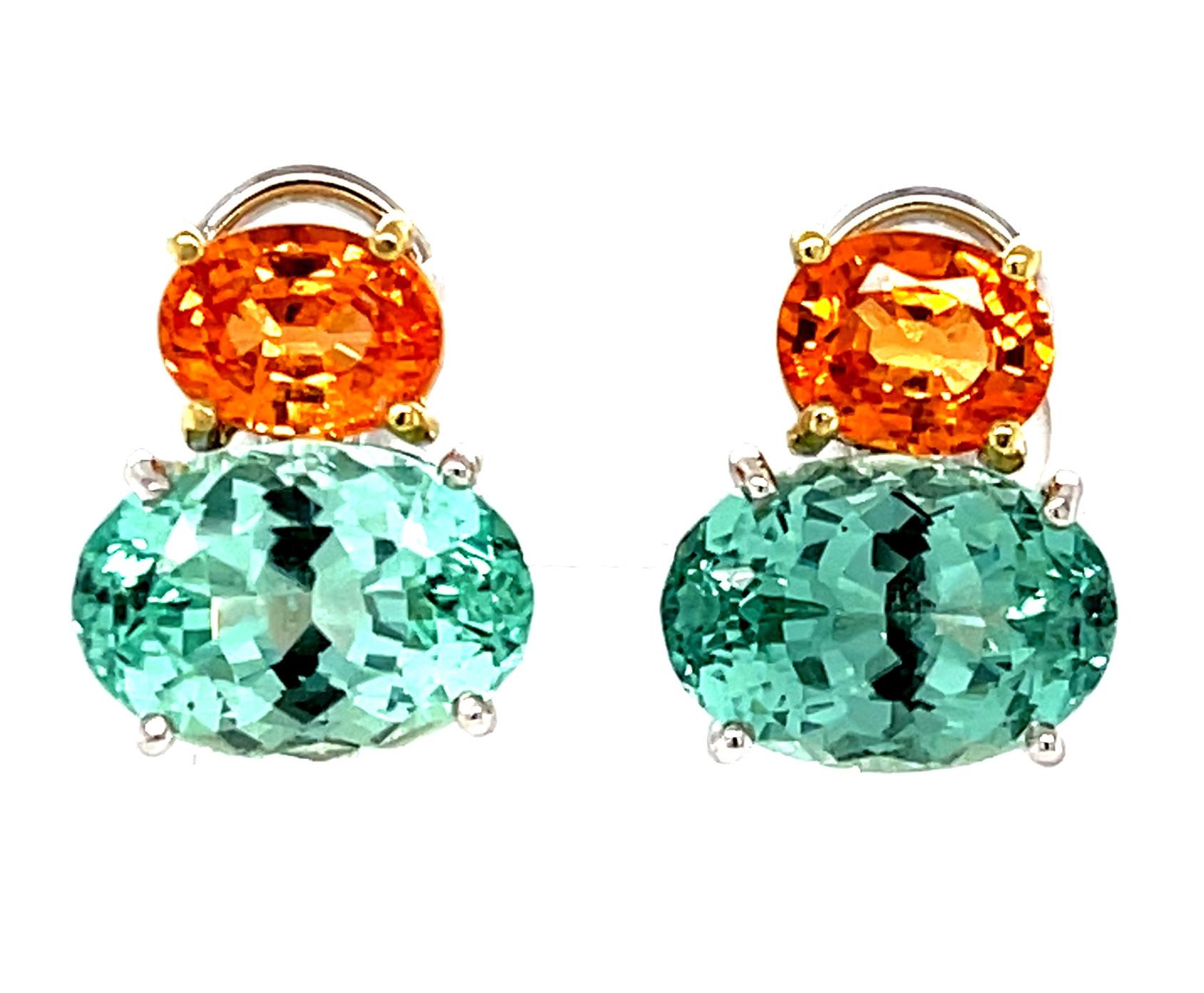 A chic pairing of color is displayed by this lovely pair of earrings. Bright, Mandarin-orange spessartite garnets are combined with sea foam green tourmalines to form a retro-inspired color block. Handmade in 18k white and yellow gold by our Master