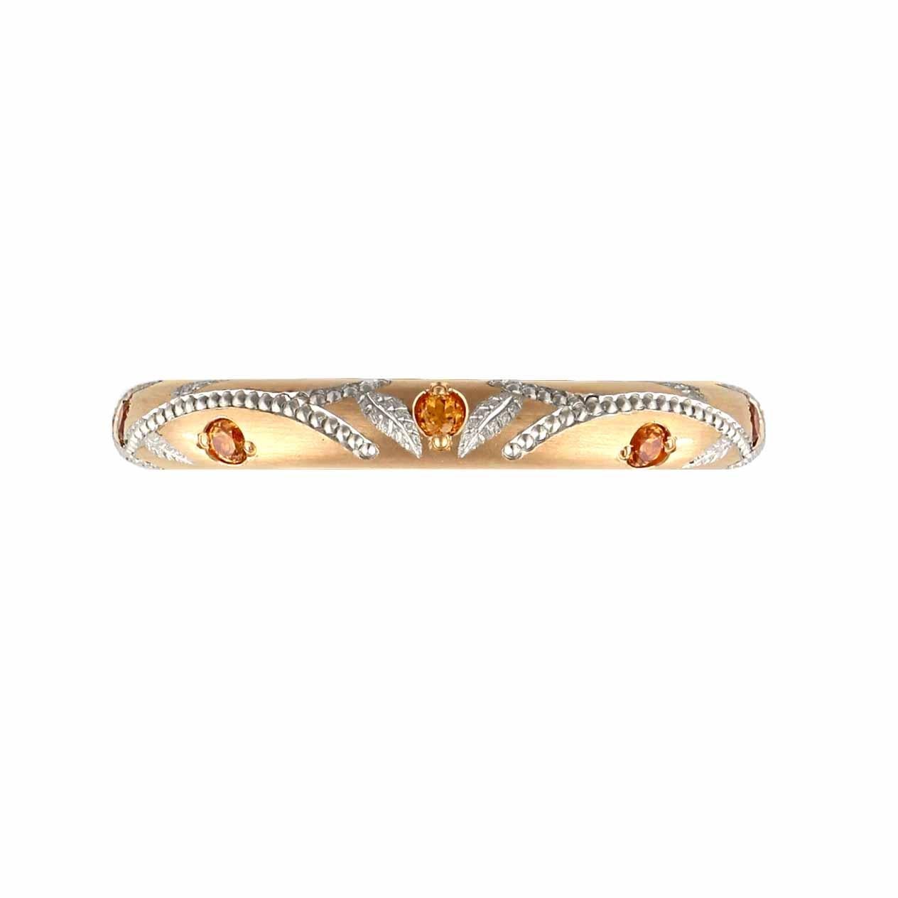 18K Rose gold band with vine pattern of pure platinum hand engraved and shaped inlay. This band has seven Spessartite Garnets. This band is made in the comfortable 'fingershape' form and it has a platinum inner sleeve. It is 3 mm wide. We also make