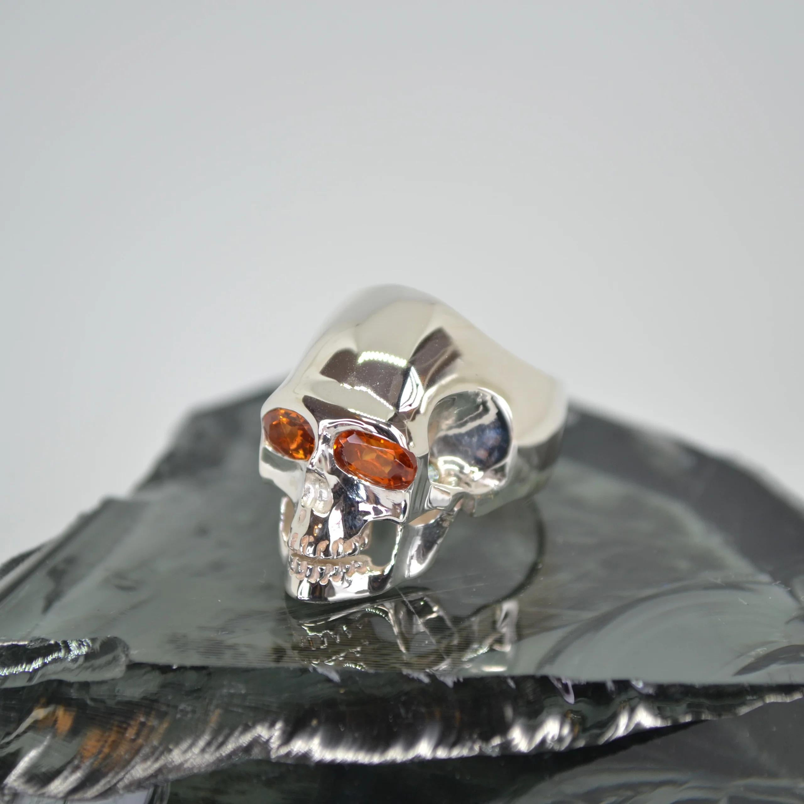 Spessartite Garnet Silver Skull Ring.
Made entirely in sterling silver.
Set with 6x4 mm Aquamarine eyes.
Fully polished solid 925 ring.
Handcrafted design.
An alternative style garnet set skull ring.
Size K on the UK finger size scale.
Designed to