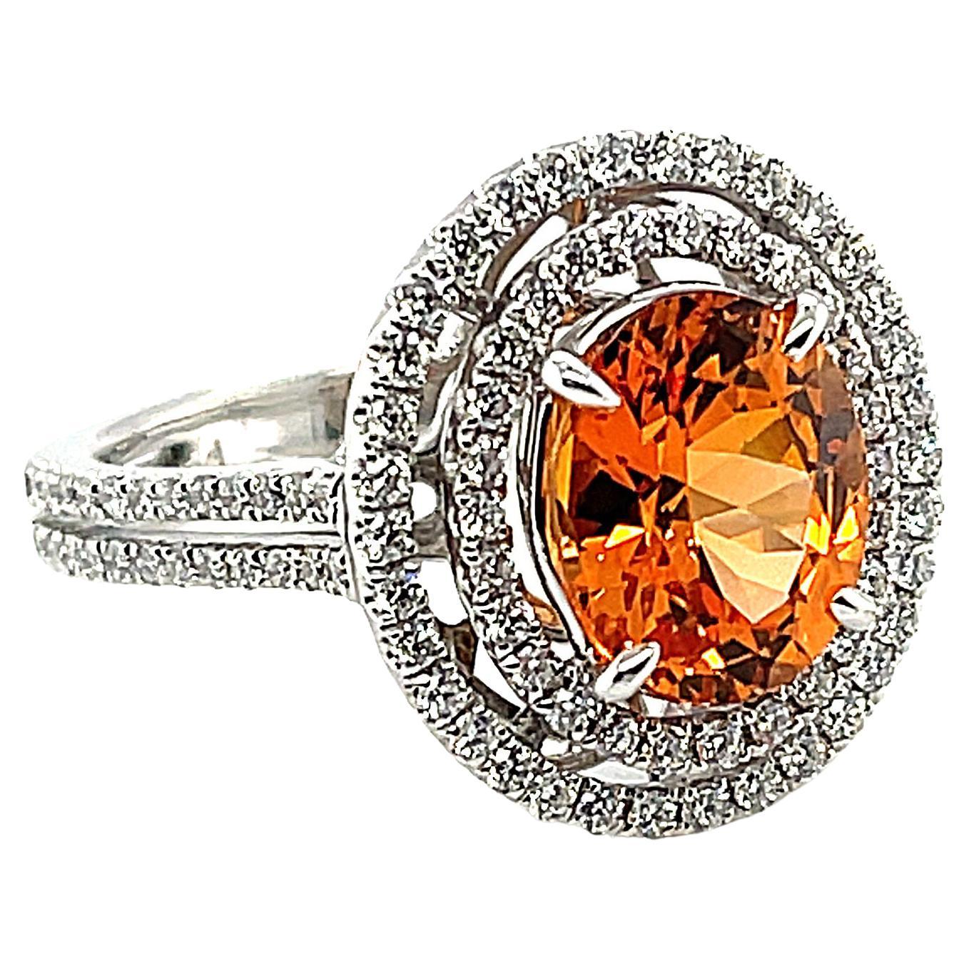 Treat yourself, or surprise your loved one with this breathtaking Mandarin garnet and diamond halo ring! 