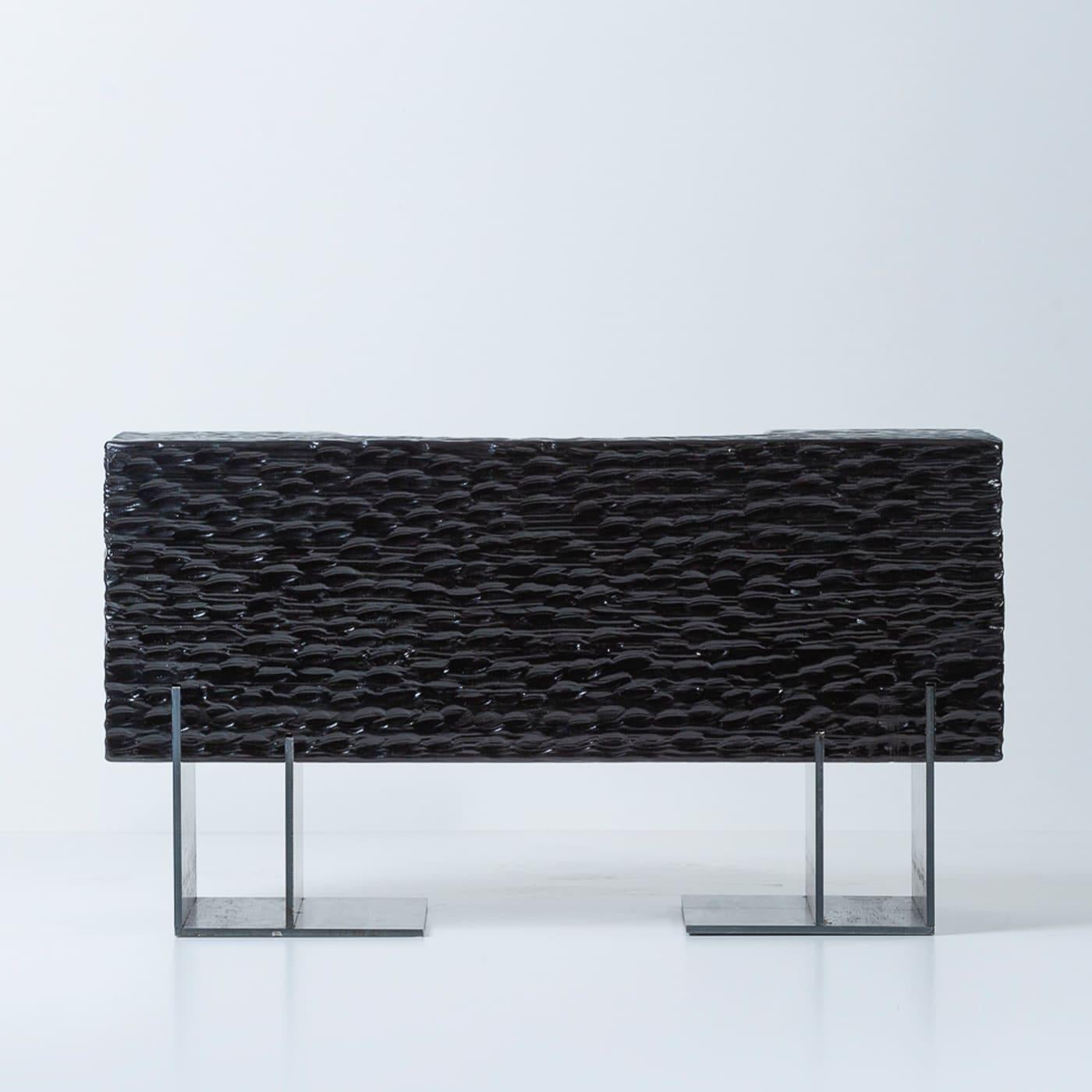 This statement-making bench captures the innate charm of organic shapes merged with the unrivaled mastery of skilled craftsmen. Raised on a sculptural base in black-oxide-finished iron, the stately structure in Douglas fir flaunts a